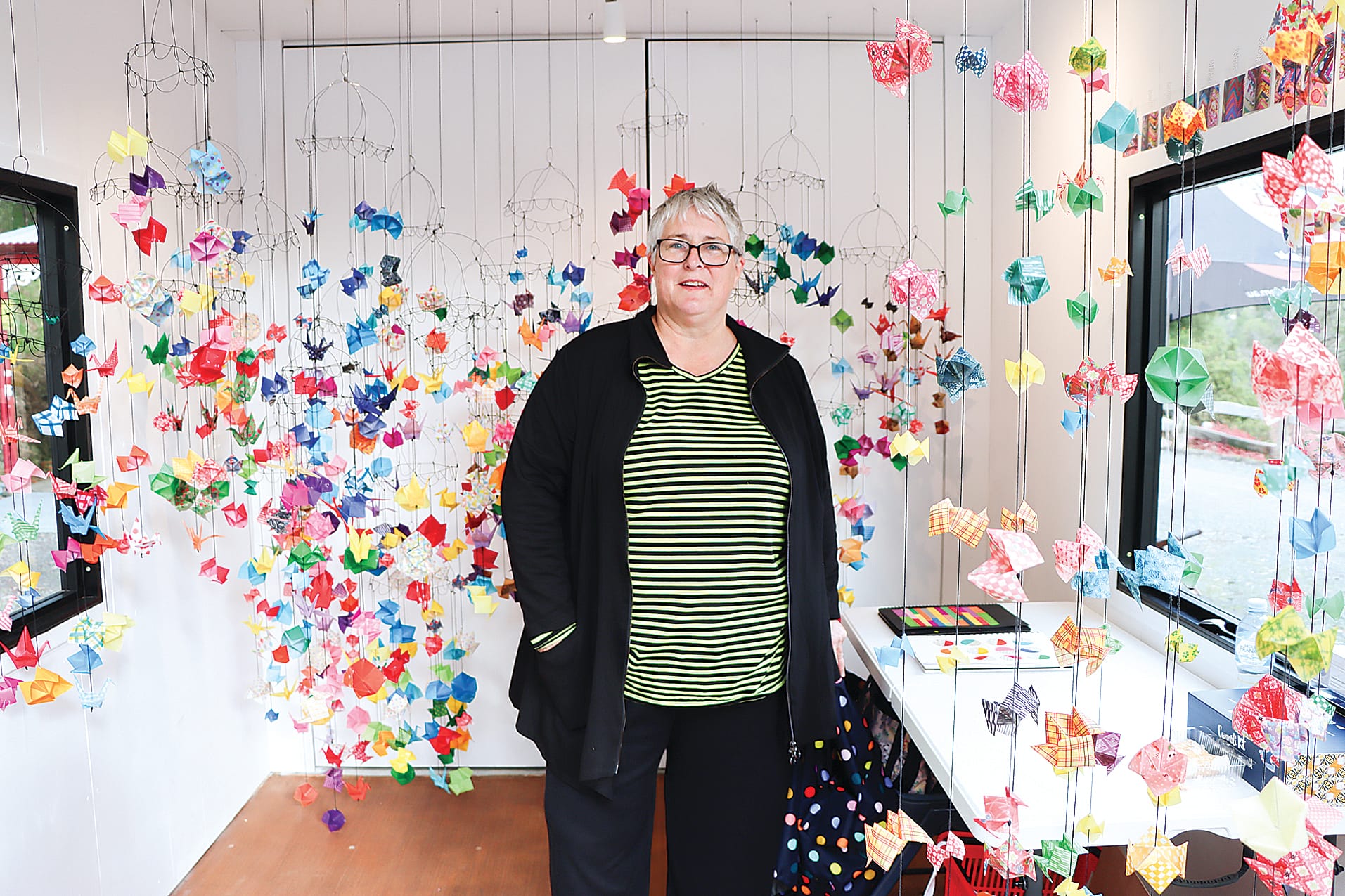 Ann-Maree Gentile stands in the ArtCube she has brought to life with her striking origami birds.