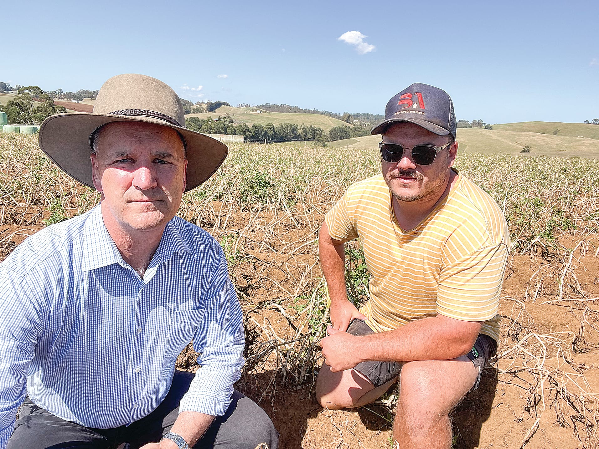 The Nationals Member for Gippsland South Danny O’Brien with Mirboo North potato grower Jesse Giardina and a crop of damaged potatoes.