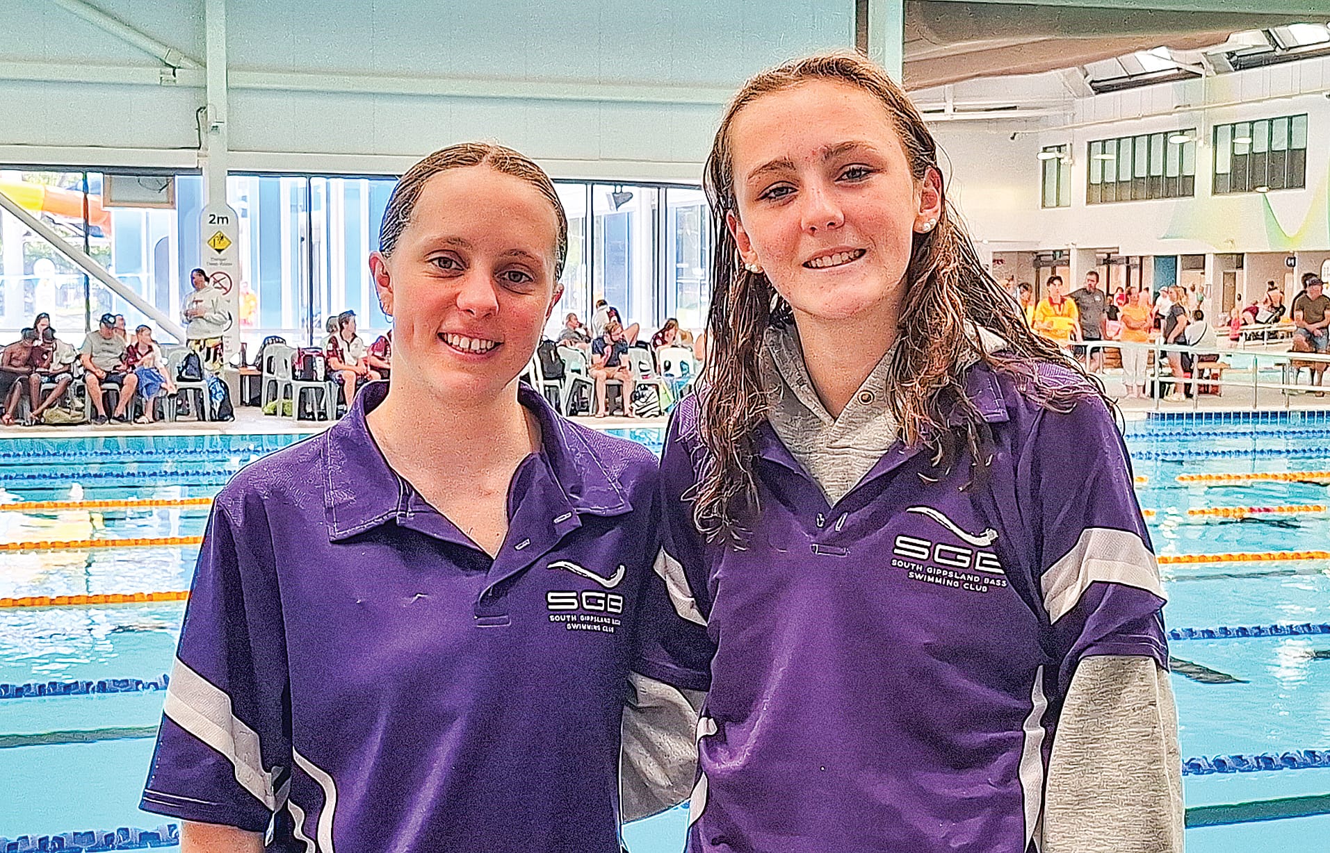 Bec and Trinity celebrating their respective age group wins in the 100m freestyle.