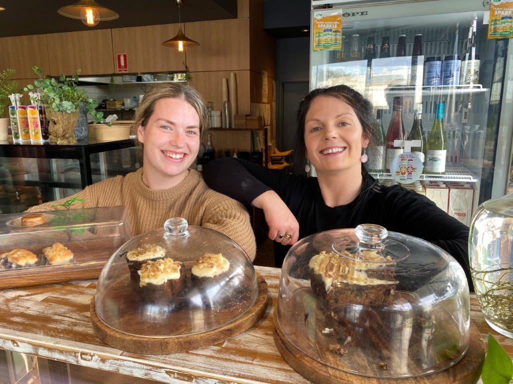 Trash Doyle and Tiarni Johnson-Douglas keep the coffees and tasty meals coming at The Bird and the Wolf Café despite floodwaters cutting off Tarwin Lower this week.