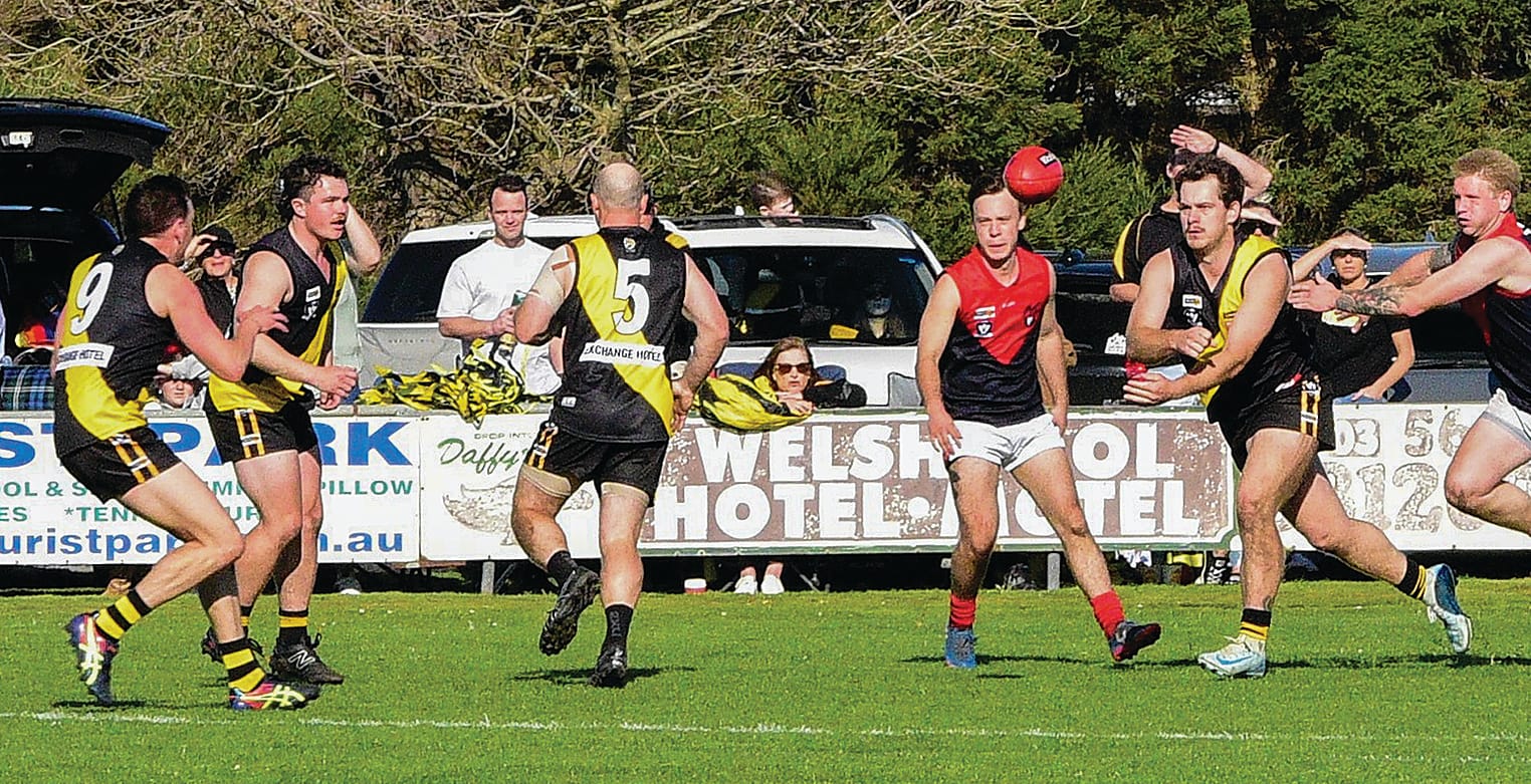 Cody Banbury gets a handball away from MDU pressure. Photo: David Bradsworth.
