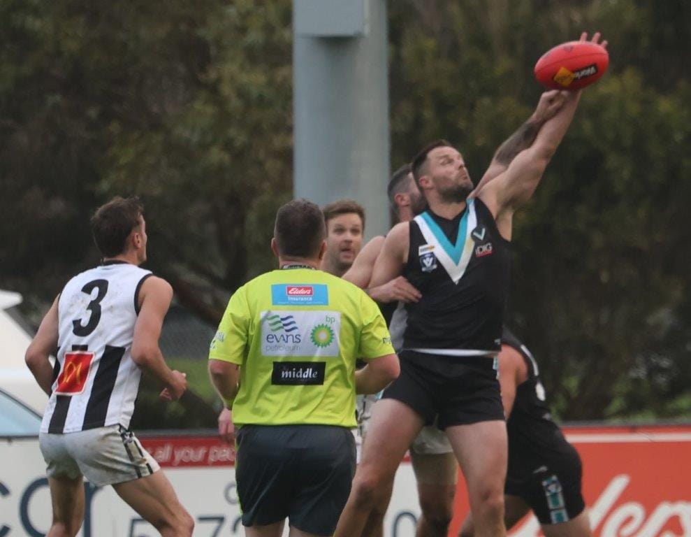 Nathan Brown gets the front position in this ruck duel on the Wonthaggi Power forward line.