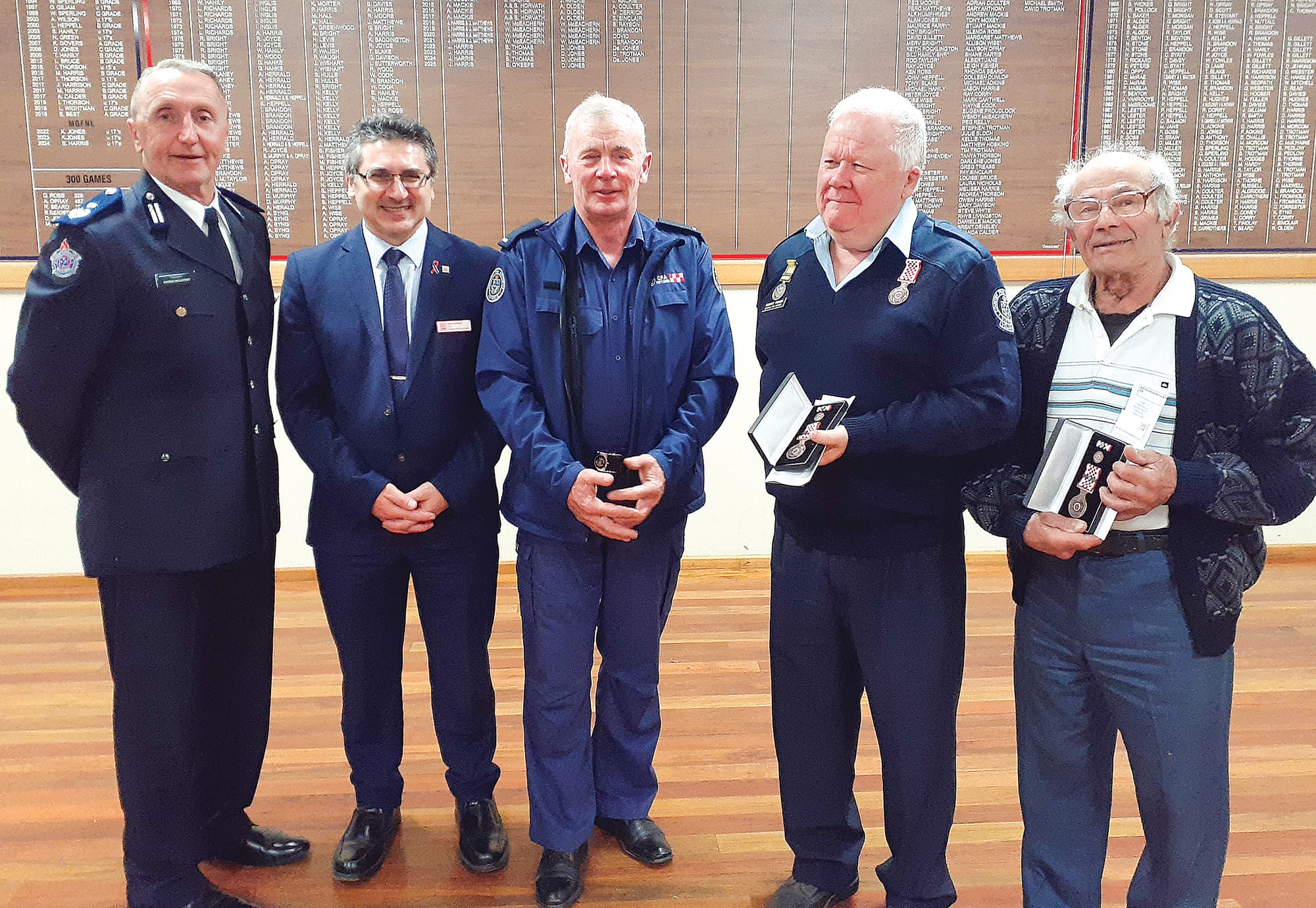 Presenting Dumbalk’s Service Awards were, from left, Commander Andrew McCartney, CFO Sam Costanzo, Captain Dallas Campbell, and recipients Rob Fisher (15 years) and Tony Maruzza (15 years).