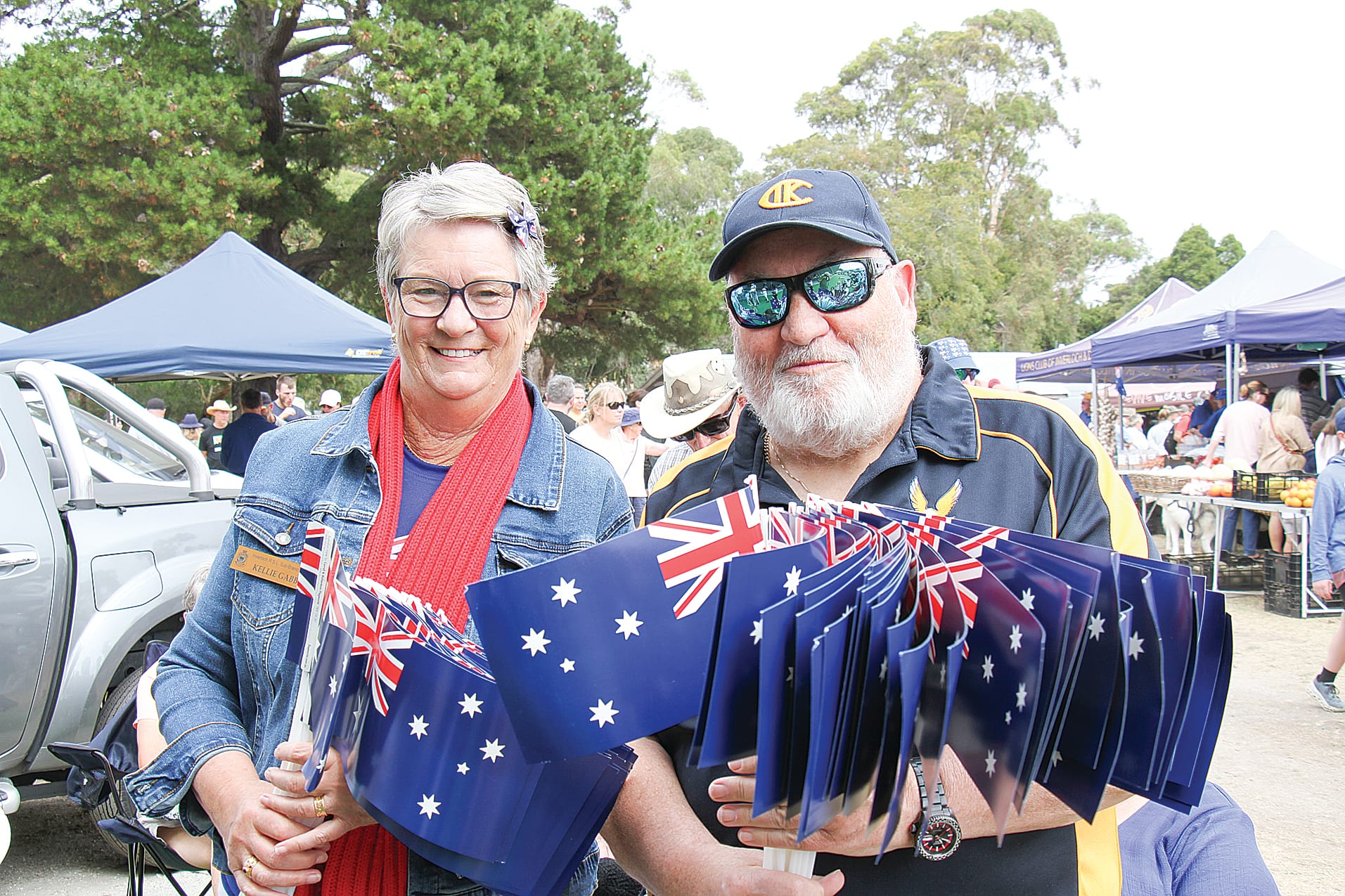 Kellie and Adrian from the Inverloch RSL handed out flags at the Inverloch Farmers Market. B20_0425