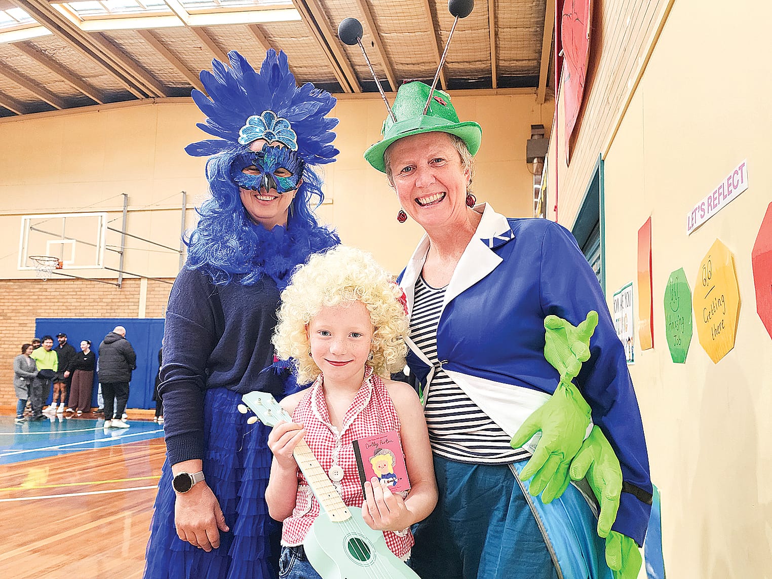 No one was left behind on Friday at Wonthaggi North, with teachers and the admin team jumping in on the book action parade. From left, Administration Officer Rachel (Chicken Divas – Britney, student Paige (as Dolly Parton (Little People Big Dreams)) and teacher Kerry (caterpillar from Alice In Wonderland). C08_3425