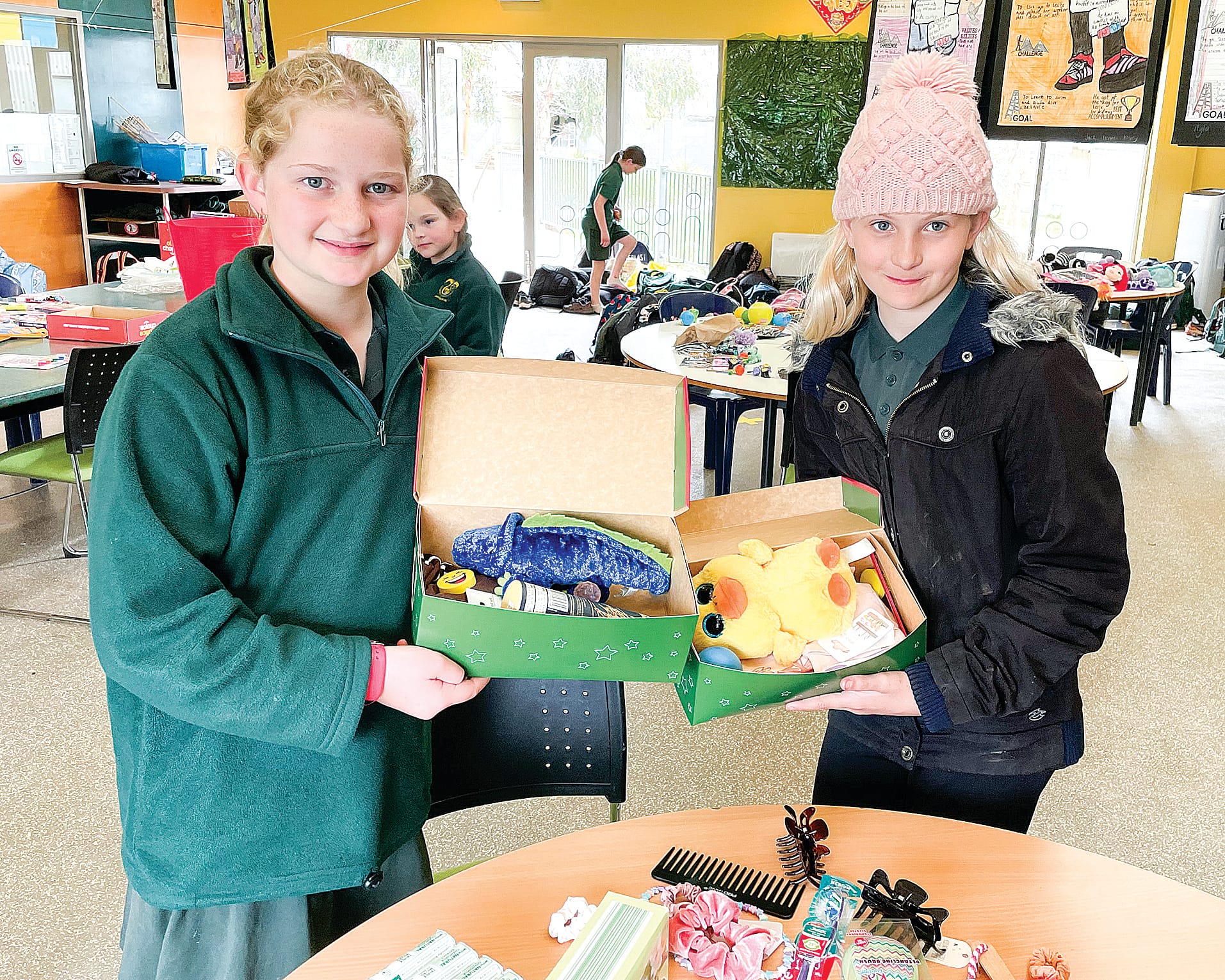 Ruby and Nikaiya display some of the gifts they have packed for Operation Christmas Child.