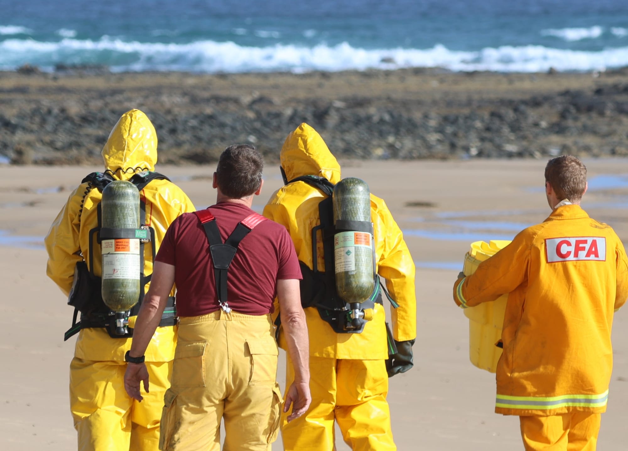 Fire officers set up a containment station on the beach ahead of recovering the potentially hazardous drum.