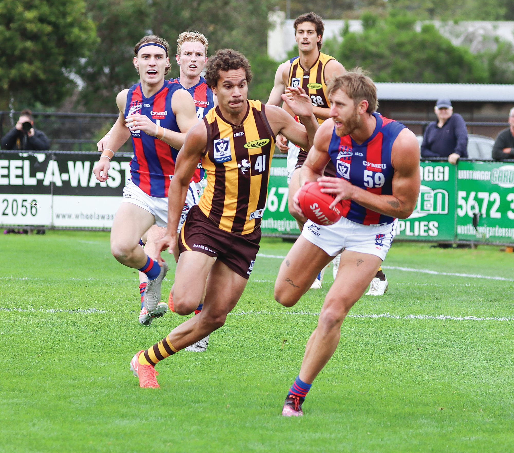 Port Melbourne’s Dyson Heppell searches for a teammate as Matthew Hill of Box Hill closes in. A48_1725
