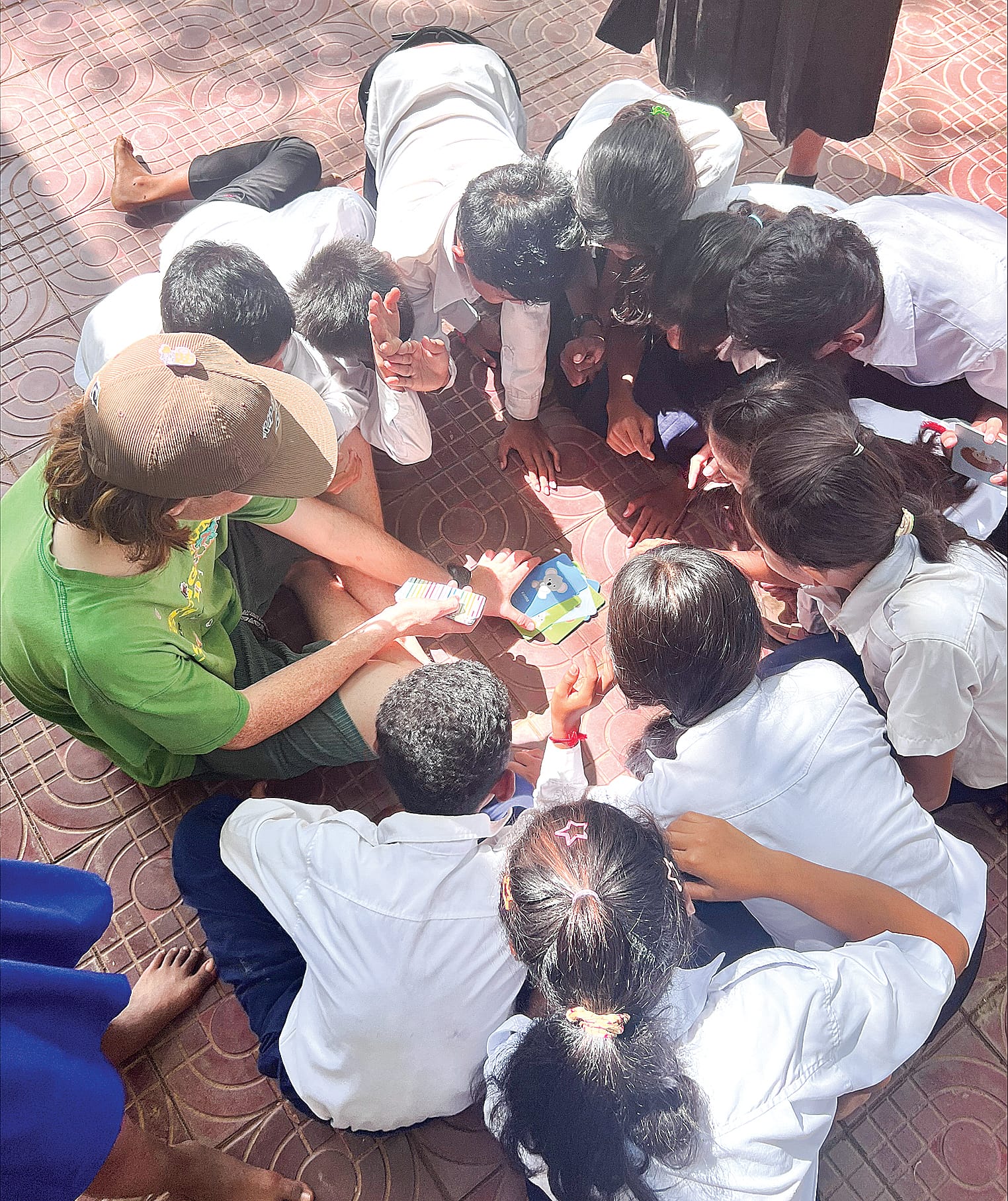 Year 10 student Finlay Cameron’s card game drew quite a crowd at Vihear Sour Primary School.