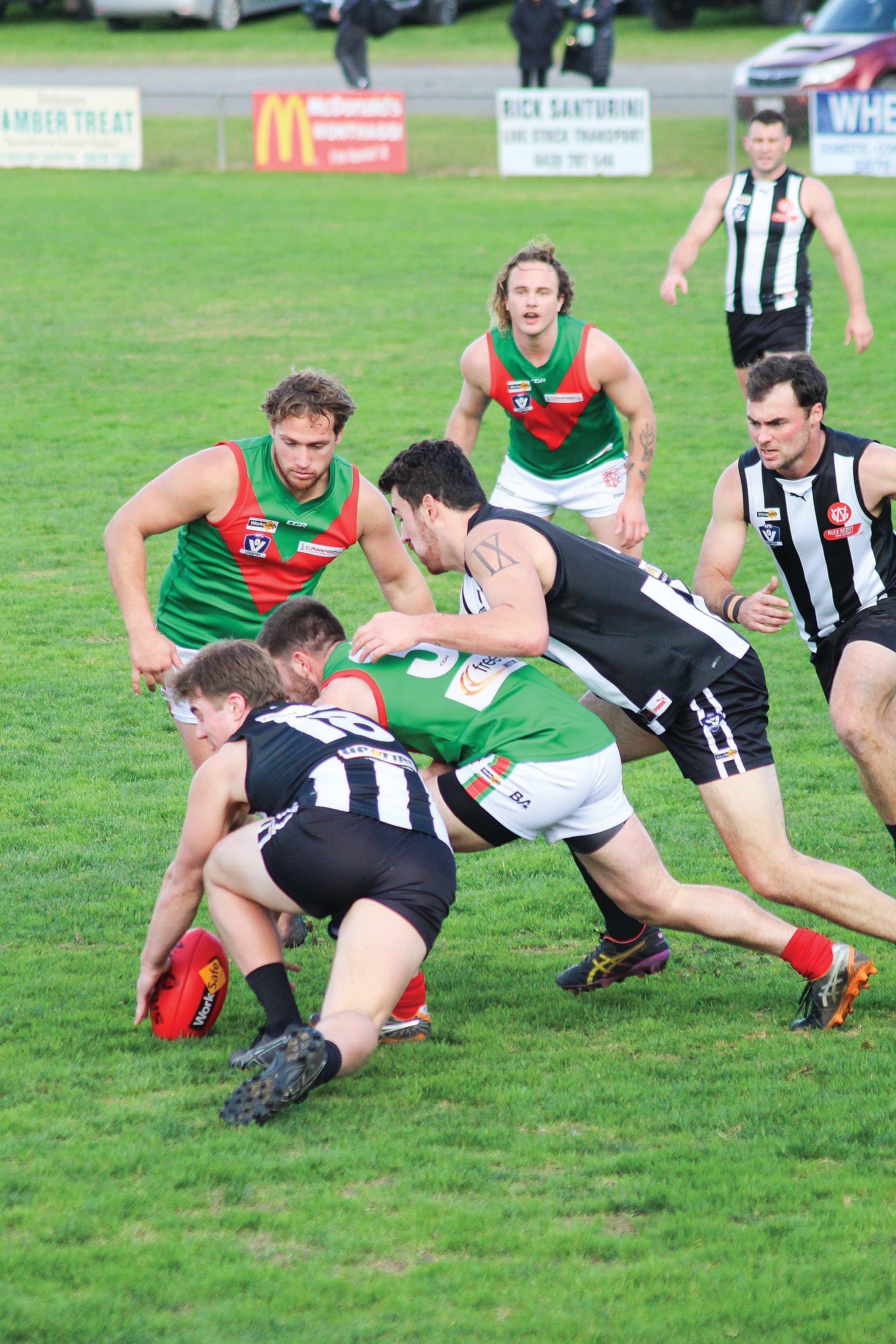 Down but not out, Jaxon Foon secures the ball. Photo: Michelle Chisholm.