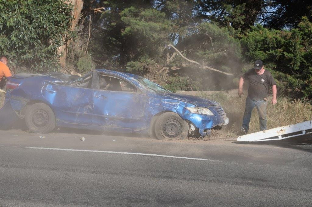 The extensively damaged car is flipped back on to its wheels.