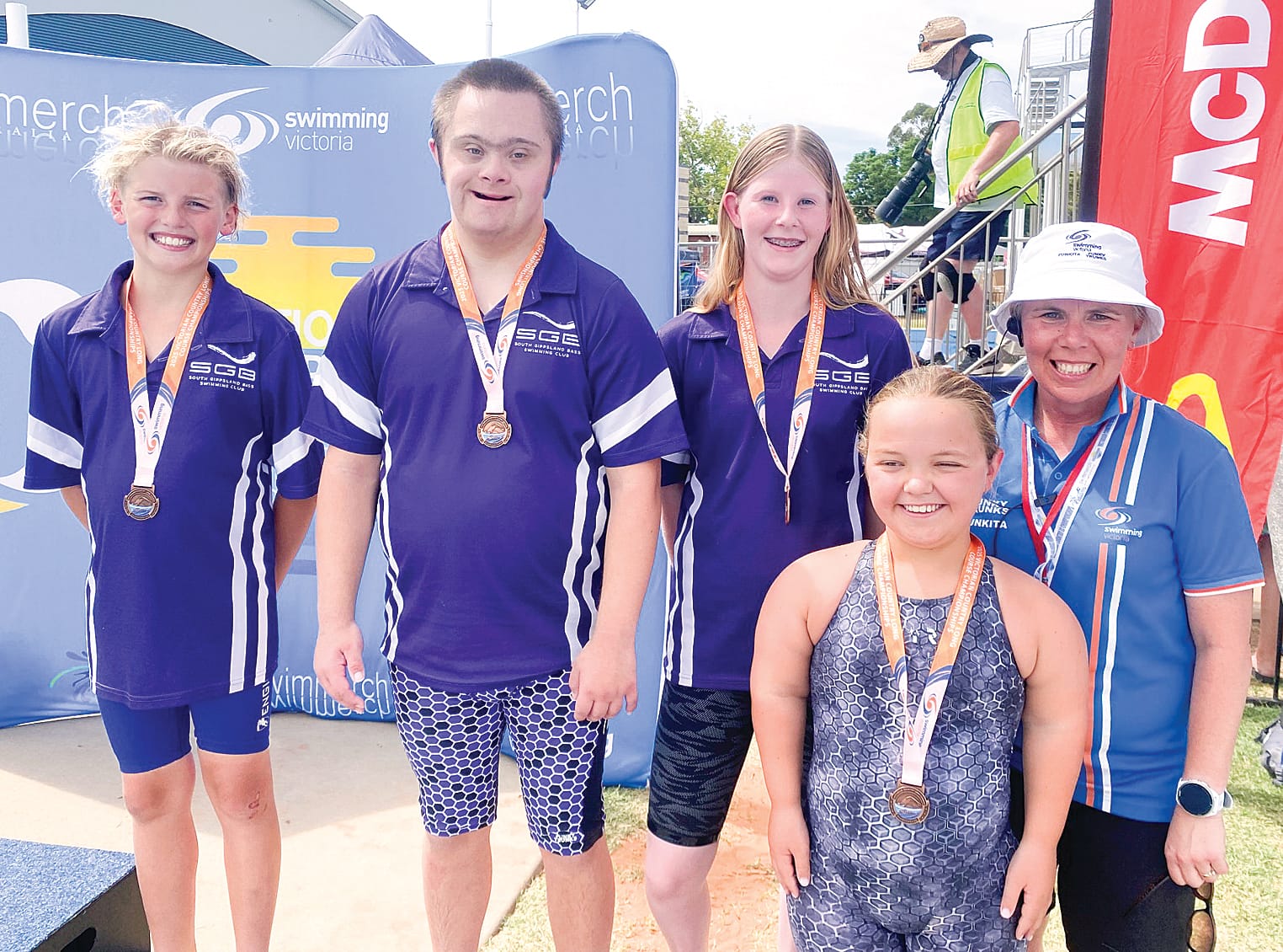 Bronze medal relay members celebrate the Para-able bodies medal with SwimVic President Michelle Harris.