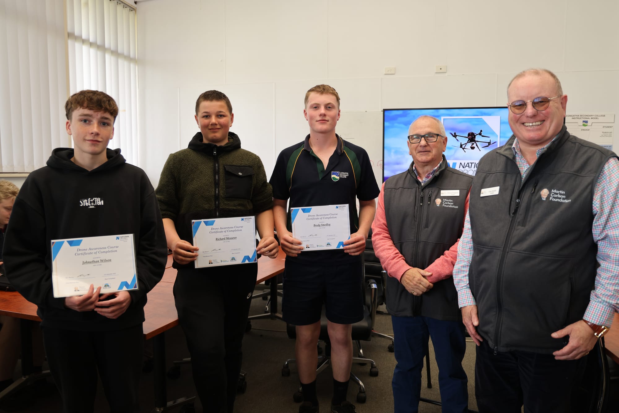 Jonathan, Richard and Brody receiving their Drone Awareness Course Certificates of Completion from Martin Carlson Foundation Trustees Darren Polglaise and Gary Brittle. B39_3725