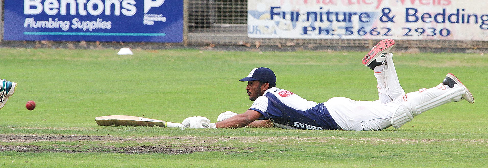 Inshaka Siriwardena dives to make his ground on the way to a match-winning performance in the A2 grand final.