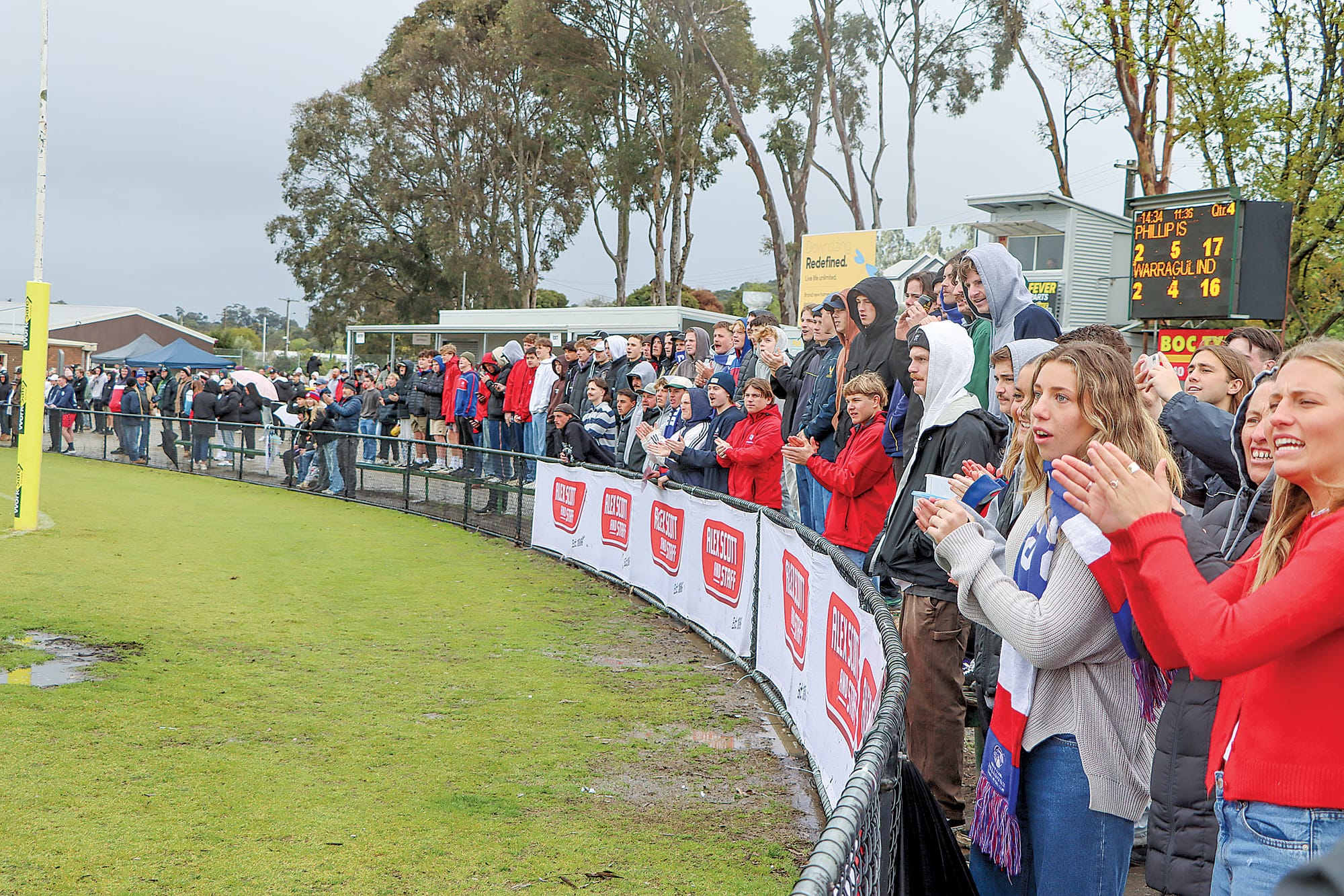Phillip Island supporters urge on their Under 18 side during the final quarter of a tight contest, later celebrating victory over Warragul Industrials. A30_3824