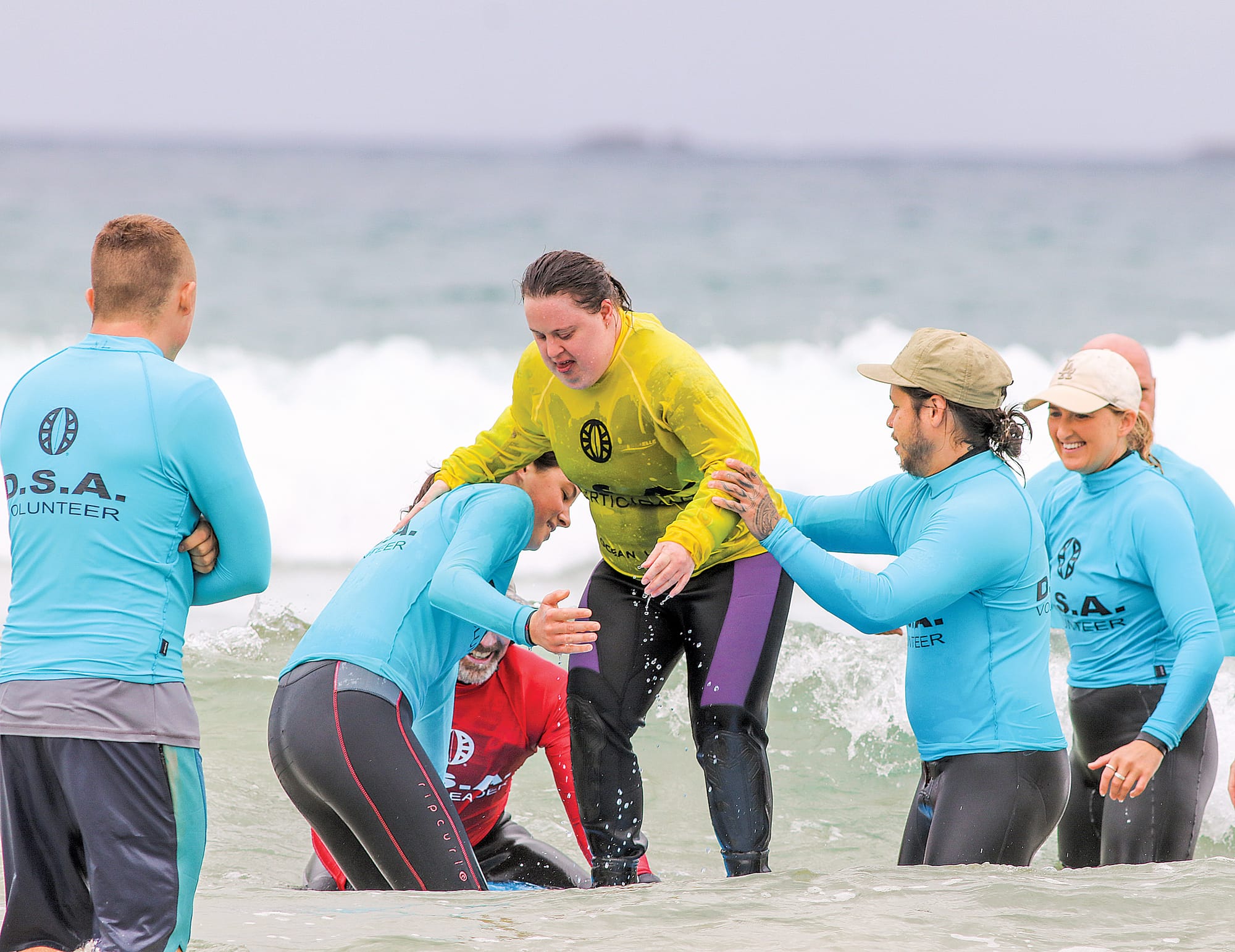 It takes several volunteers to help participants enter the water safely and when they catch a wave the excitement is infectious. Z16_4622