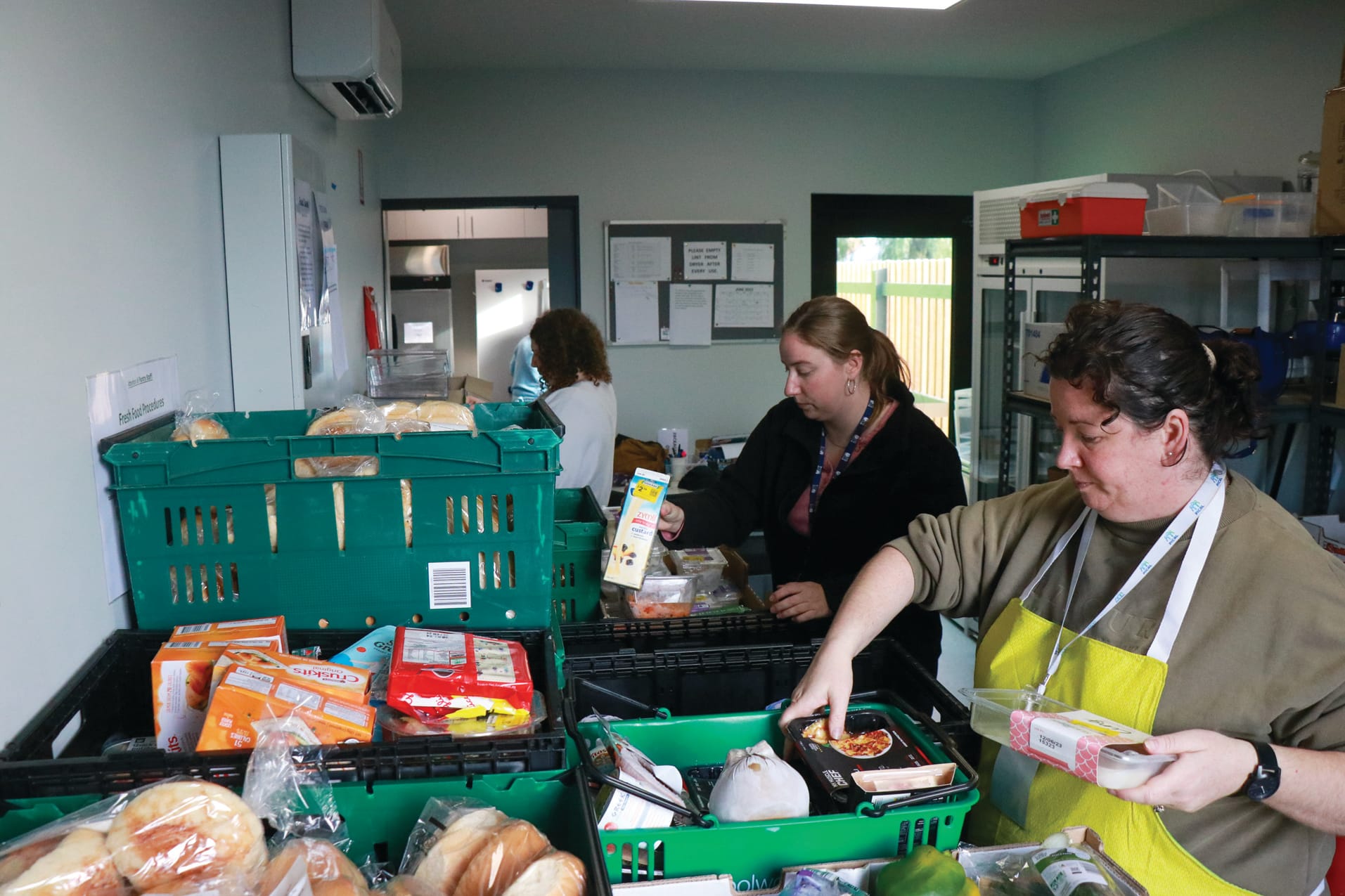 Savana, Hayley and Felicity volunteer their time every Tuesday in the PICAL pantry to assist the community through the cost-of-living crisis. Z01_2523