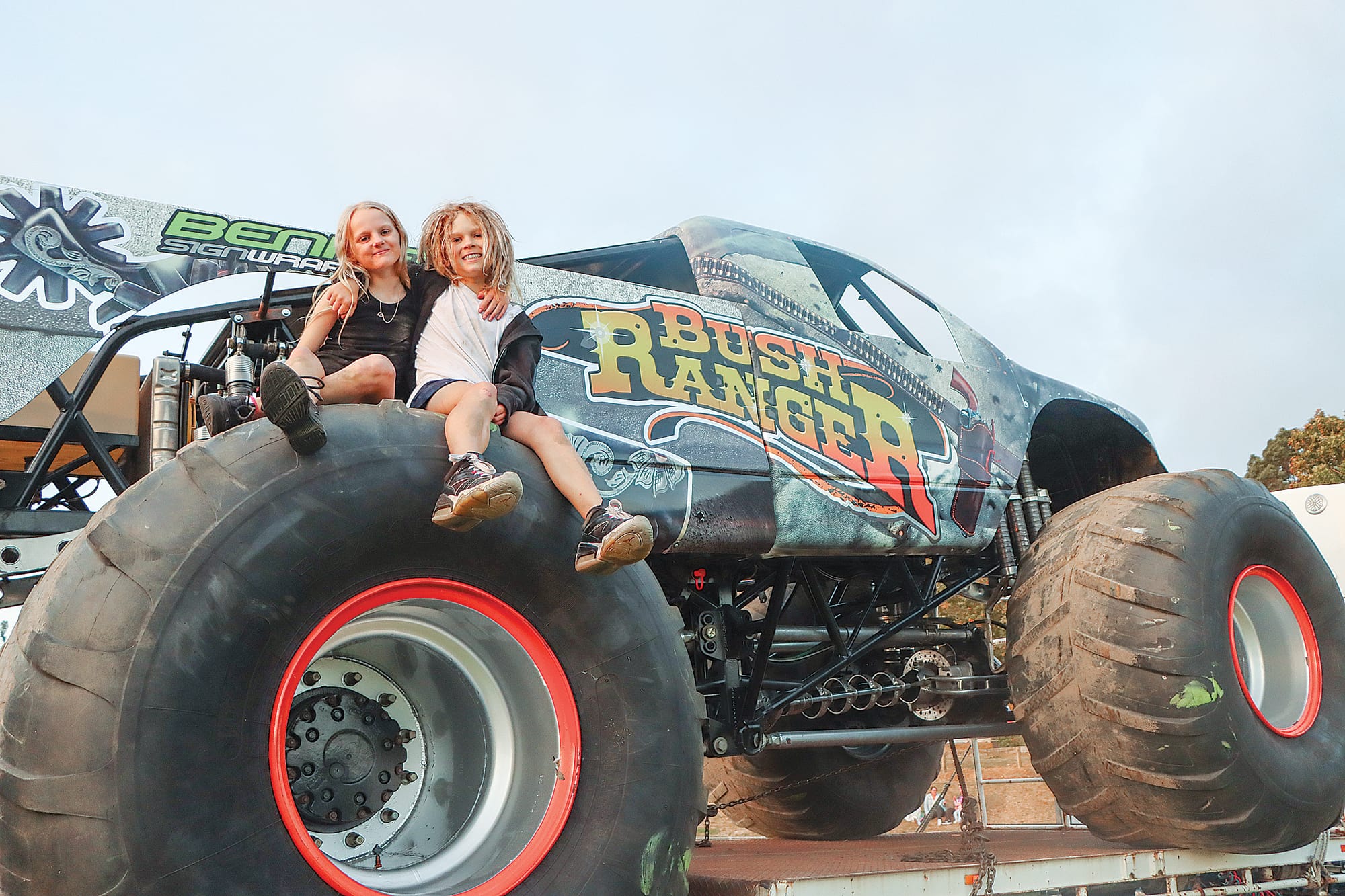Bella and Koby Hoffmann are delighted to climb aboard a monster truck. A39_0625