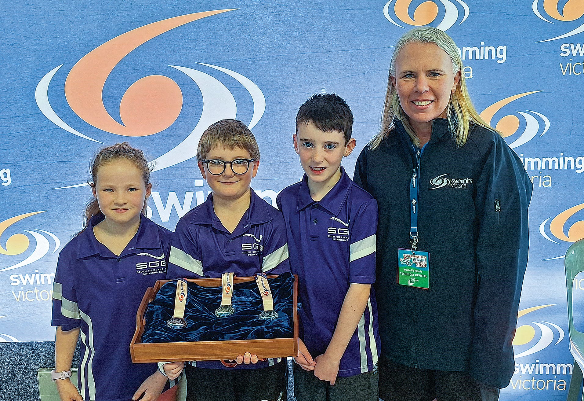 Mya, Leo and Austin helped Swim Victoria President Michelle Harris with the medal presentations.