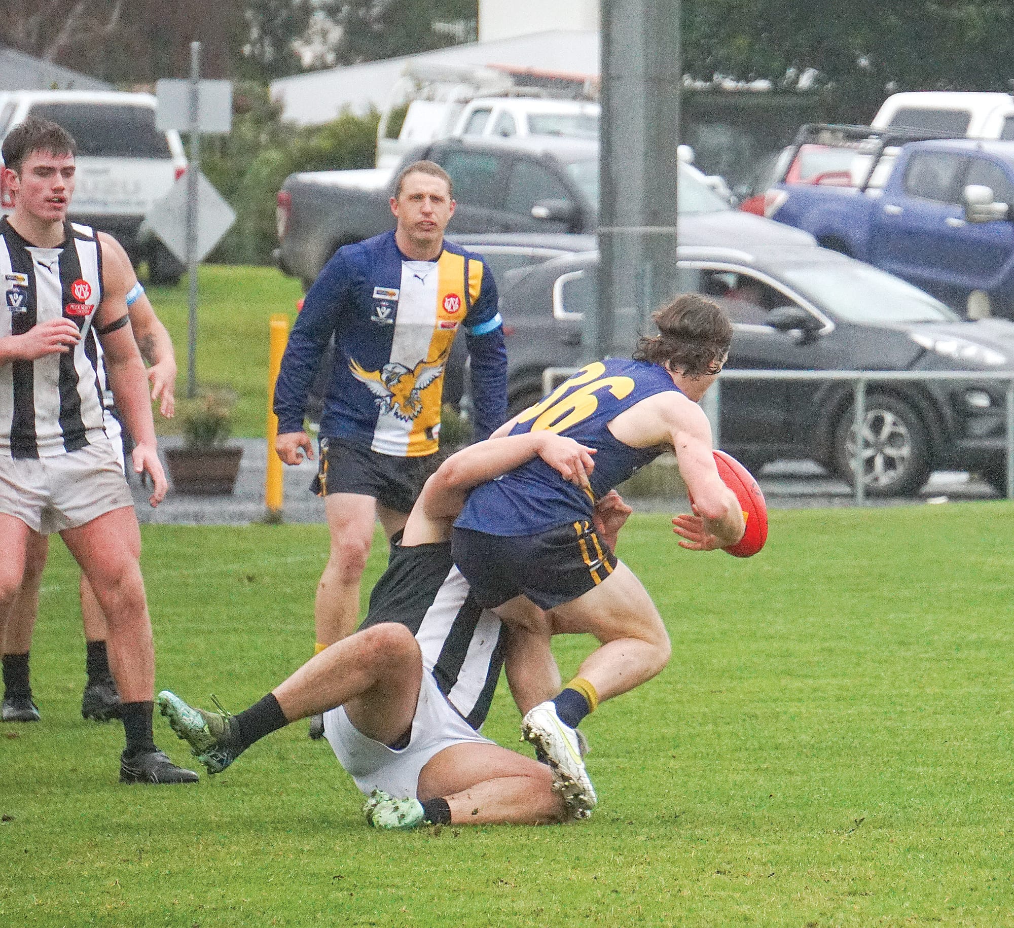 Inverloch’s Reegan Kemp looks for options as he goes down. Ns02_3024