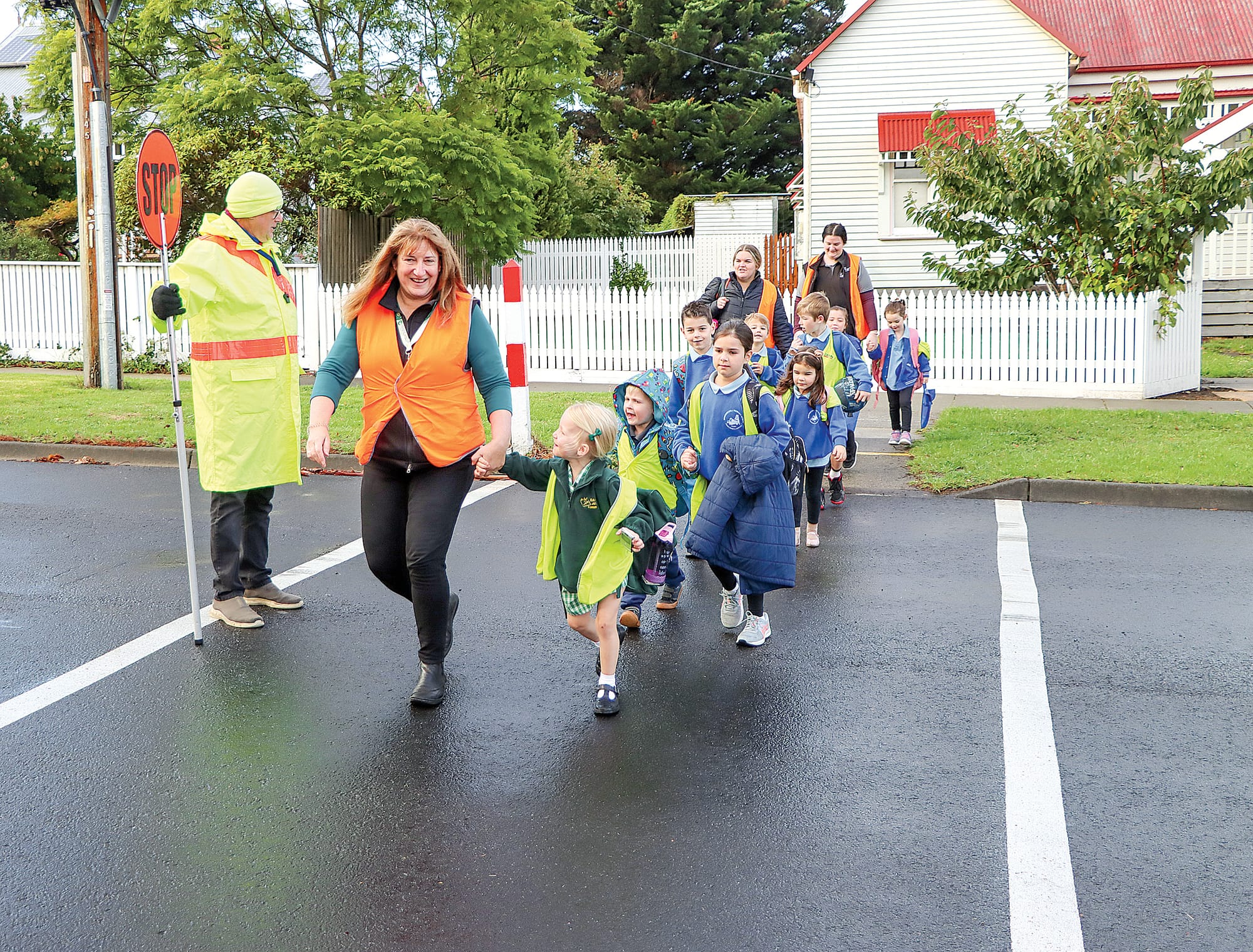 Crossing supervisor David Barker ensures safe passage for the Karmai Children’s Centre ‘Walking Bus’ group. A29_1423