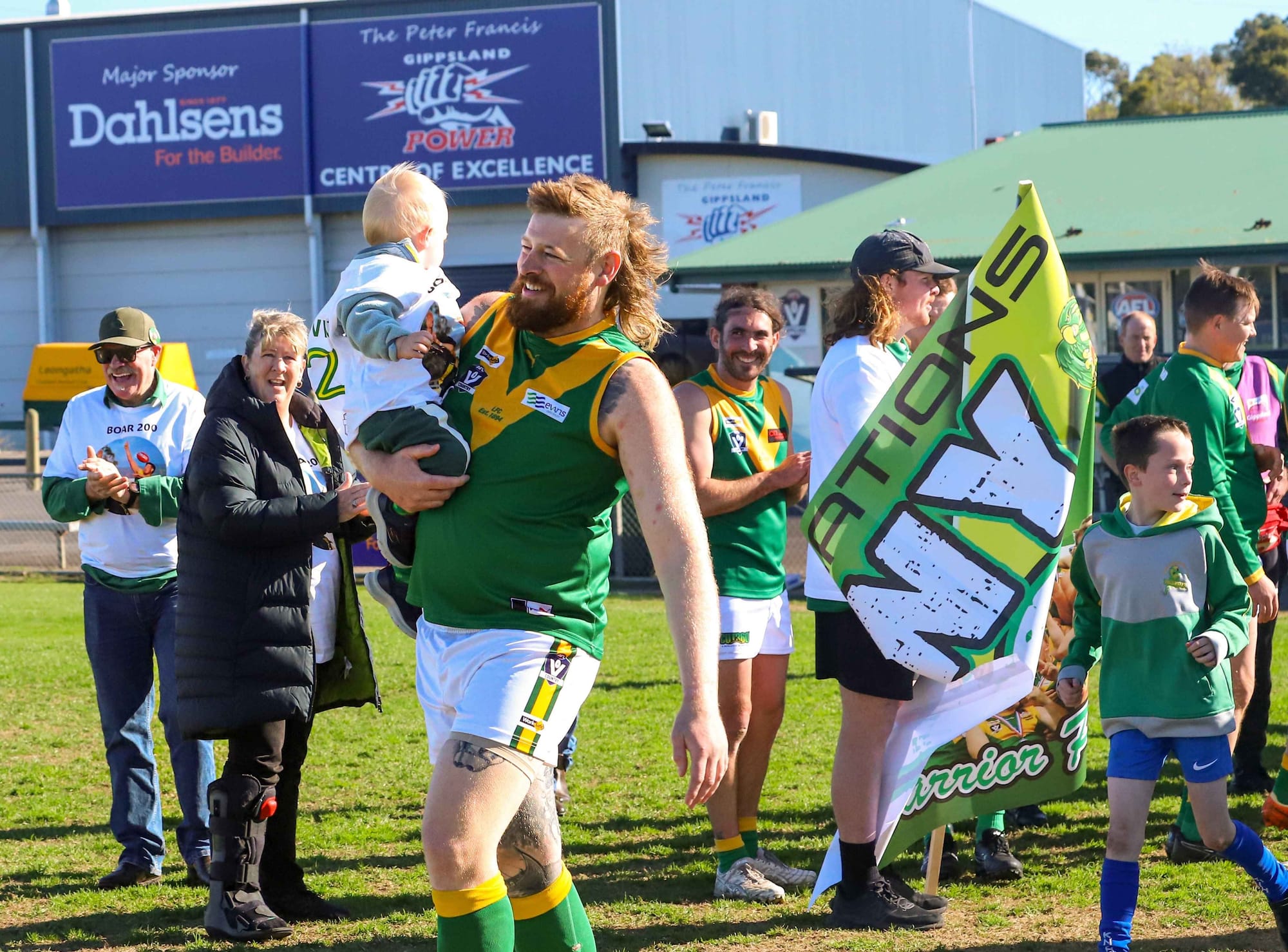 Leongatha's Benny Willis kicks a bag in 200th game celebration