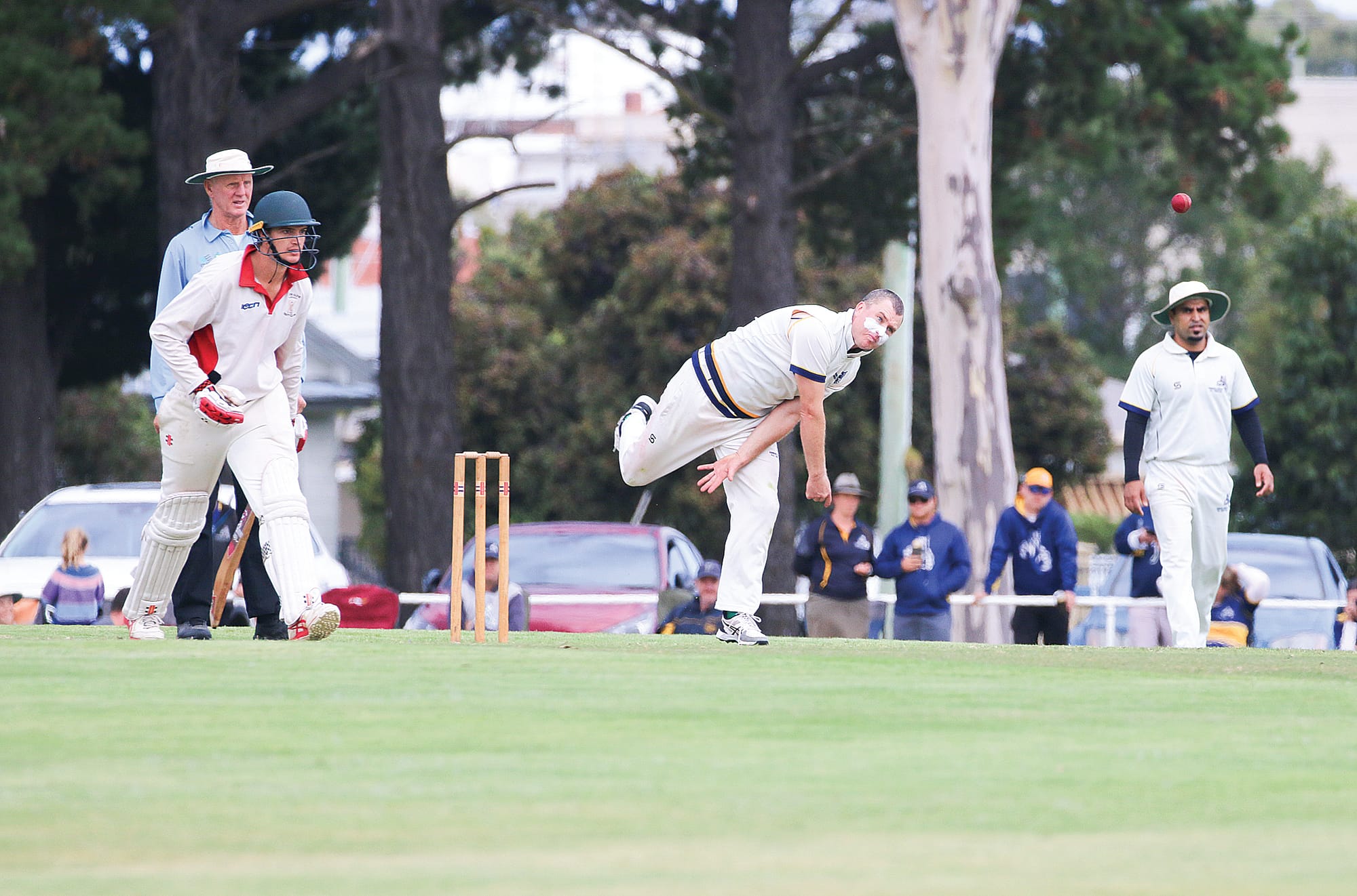 Koonwarra bowler bends his back.