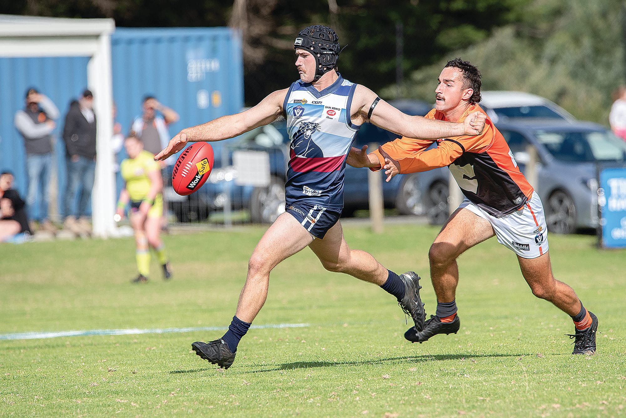 Under pressure Lachlan Burns works the ball forward for the Panthers.