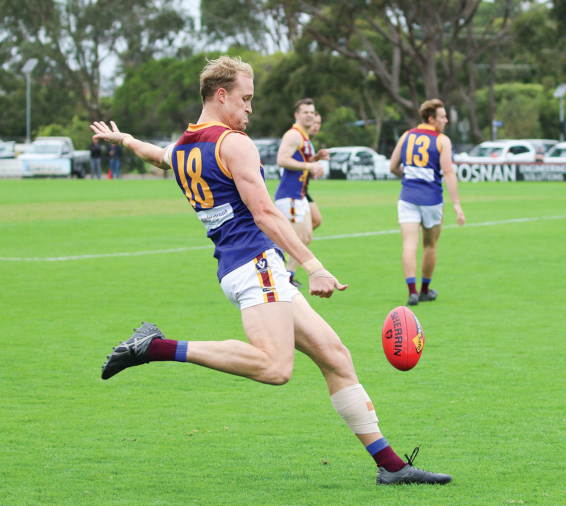 Chris Prowse for Moe takes a punt towards the goal end.