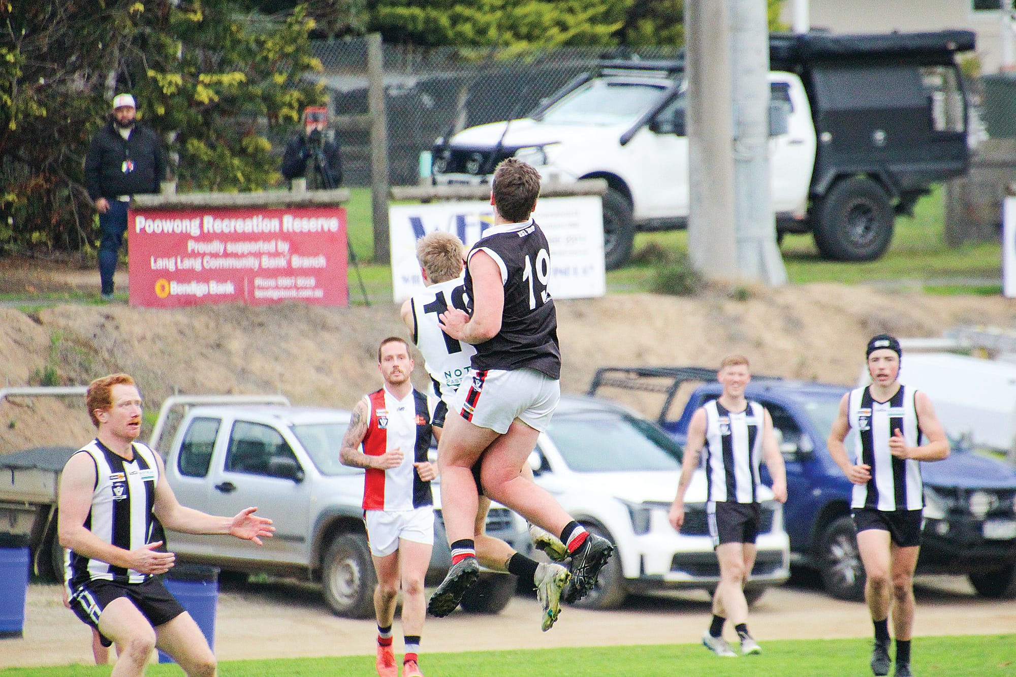Nyora’s Aaron Coggins reaches for the ball to gain advantage over his Poowong opponent.