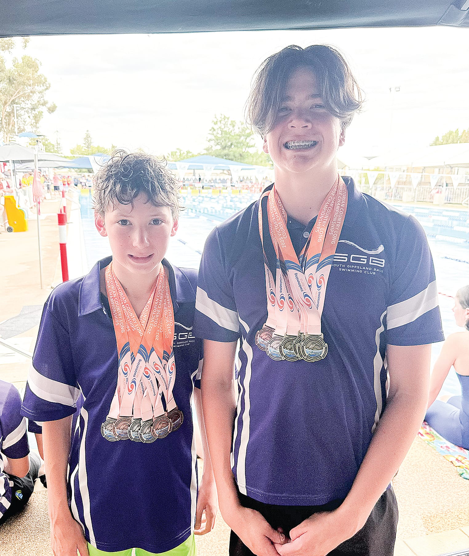 Levi and Archie compare their medals.