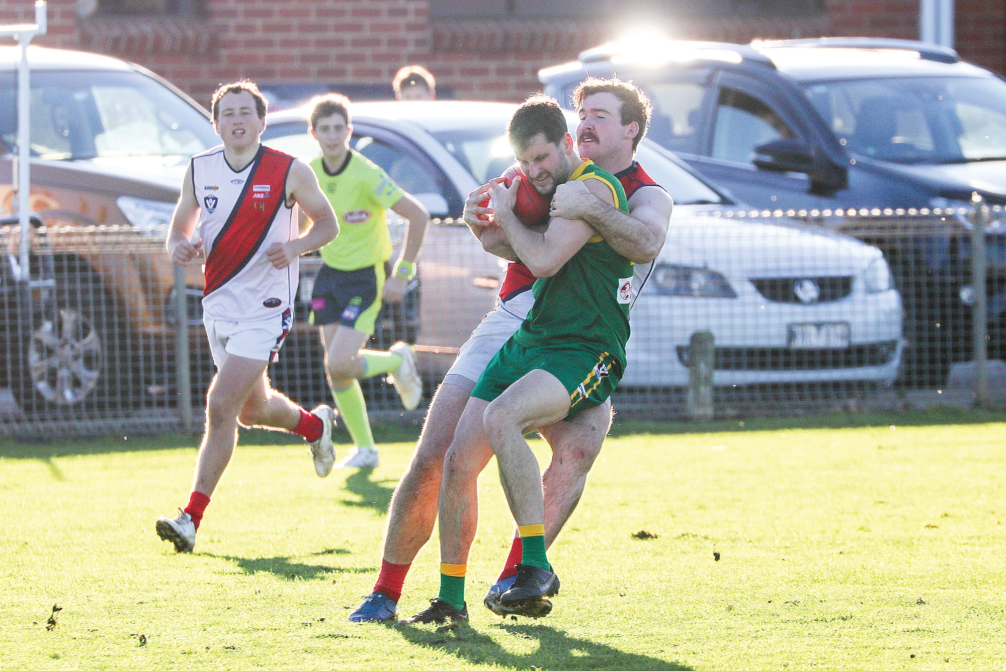 Brok Davidson playing through the strong tackle from Bairnsdale defender. w31_2725