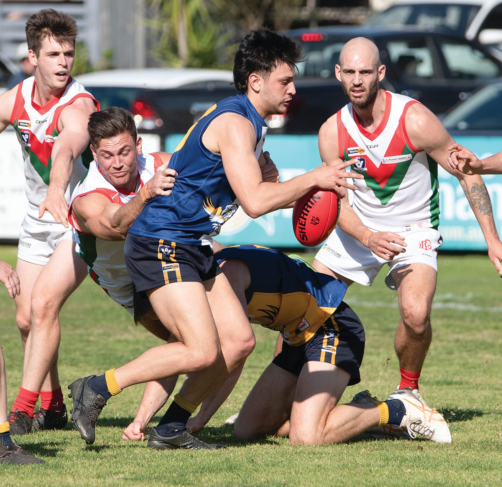 Nicholas Baltas looks for options as his Tooradin-Dalmore opponent moves in for the tackle. Photo: Anna Carson.