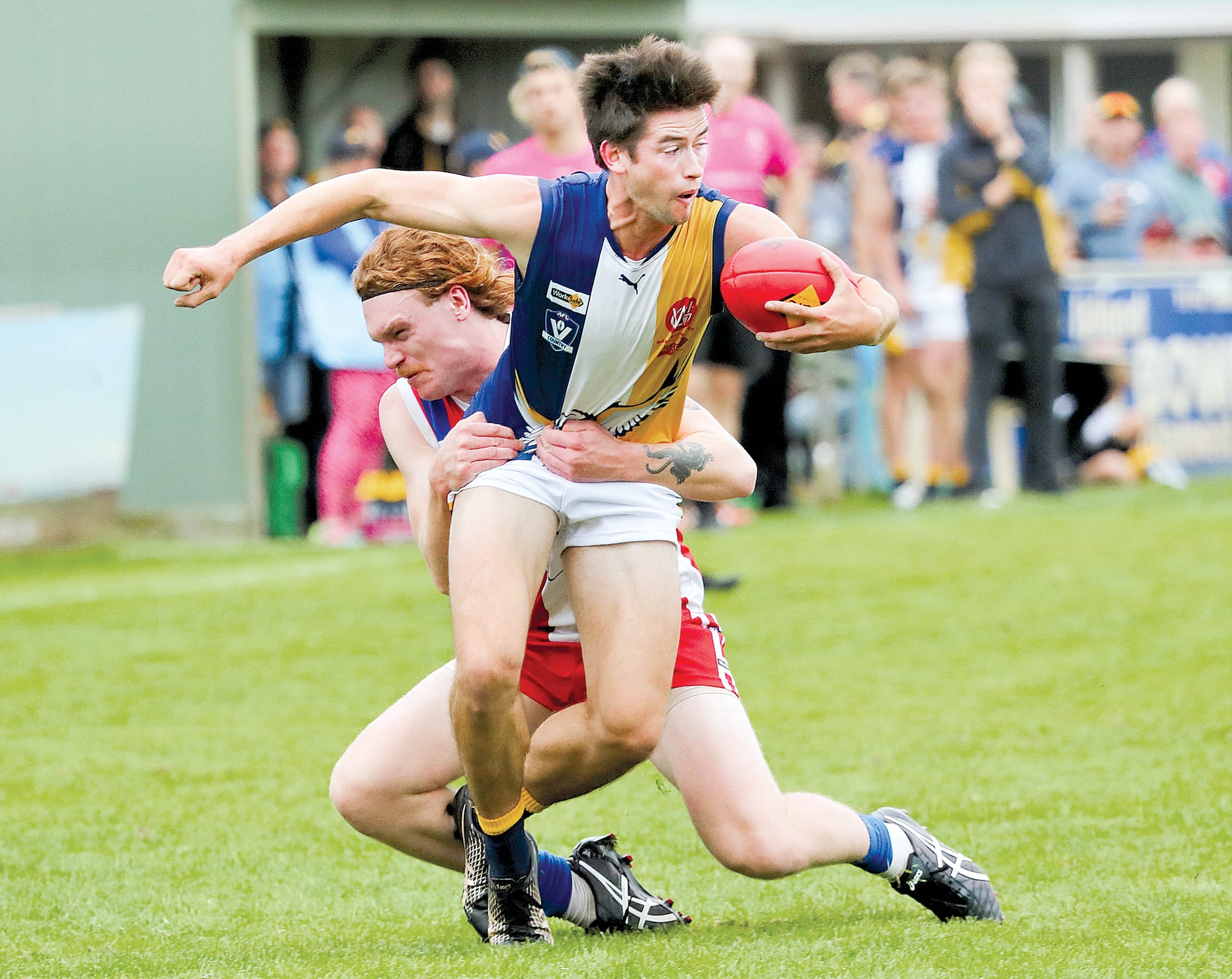 Phillip Island’s Tarquin McMillan desperately tries to deter Inverloch. Photo: Carol Ratcliff