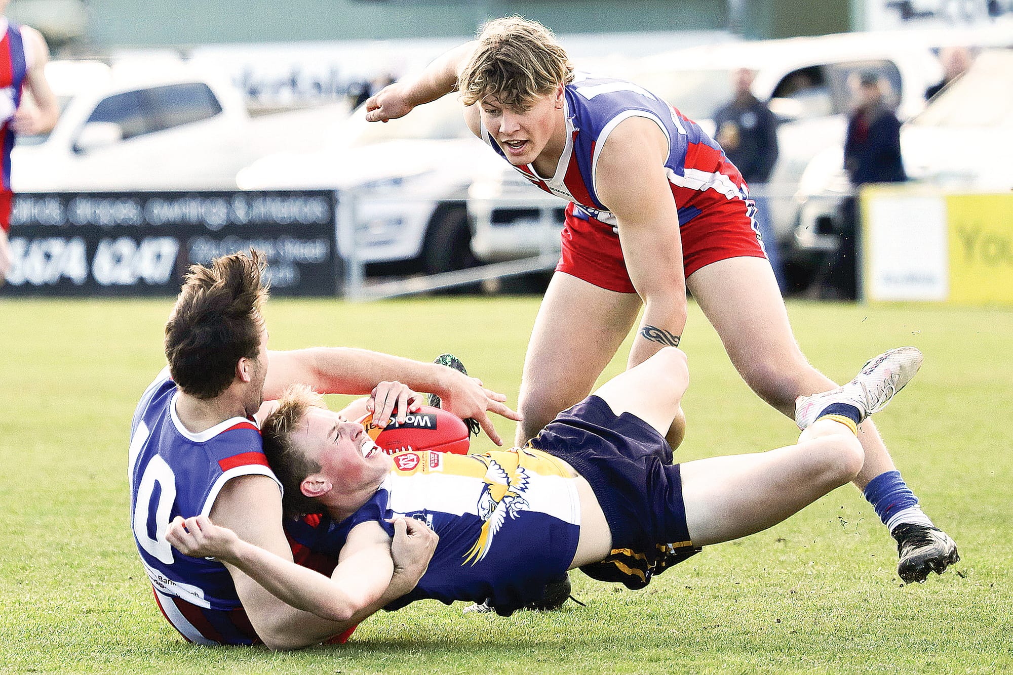 Alex Duyker successfully tackles his IK opponent to ground as Coby Olarenshaw comes in to assist. Photo: Carol Ratcliff