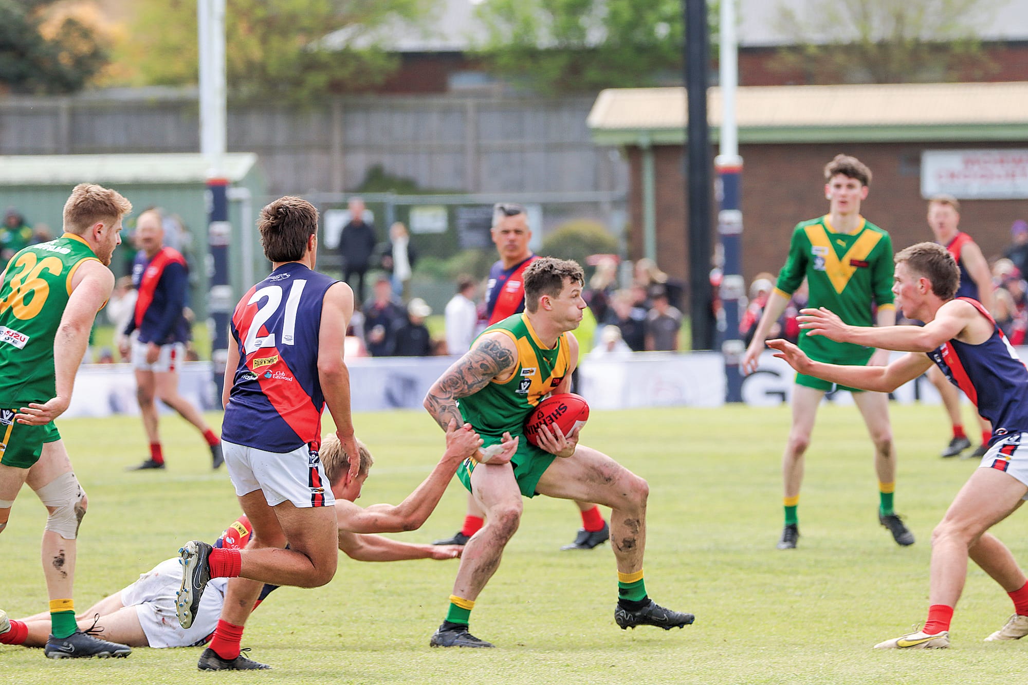 Adam Trotto strives to break free for Leongatha as Bairnsdale players pursue him. A47_3924