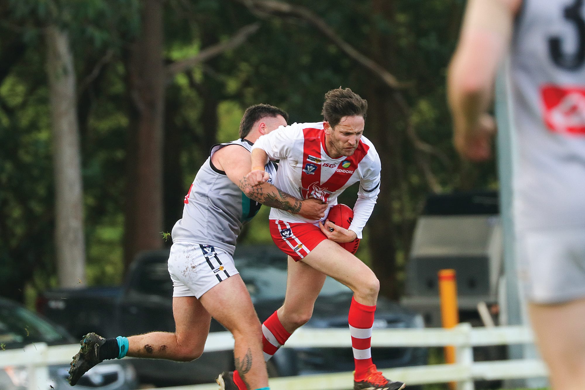 Jack Hayes keeps possession despite a good tackle and wet conditions. Z35_2924 