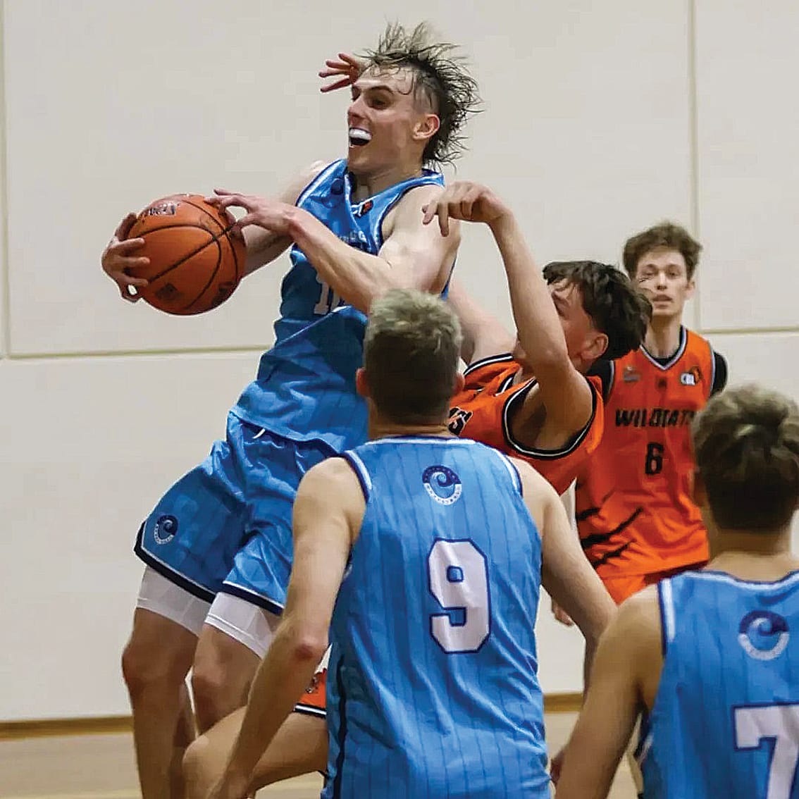 Wonthaggi’s Trent Westaway pulls in the rebound against his Wildcats opponent. He finished the game with 14 points. Photo: Basketball Victoria and Sharon Freeman.