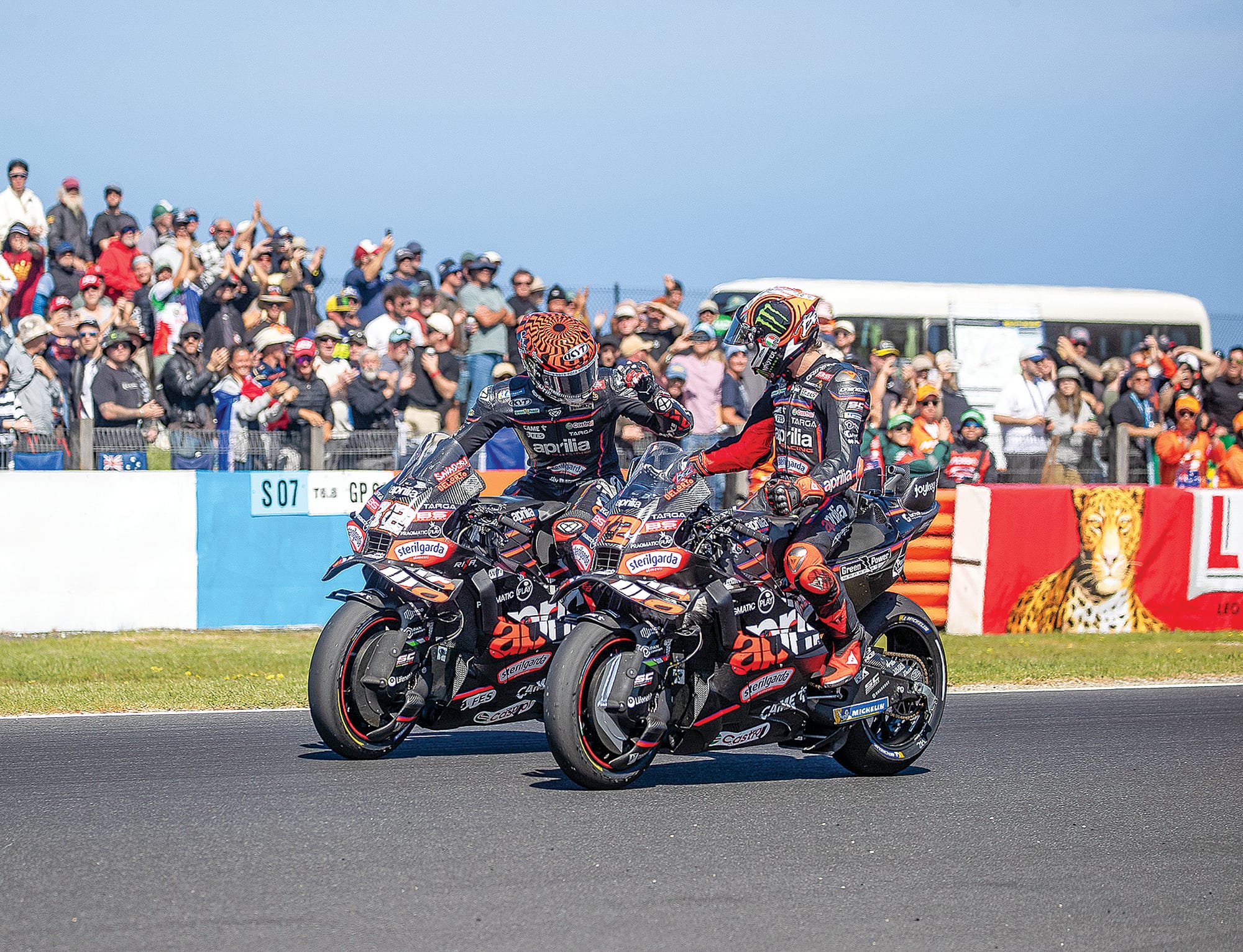 Apilia team mate Lorenzo Savadori congratulates Marco Bezzecchi on his Tissot Sprint win.