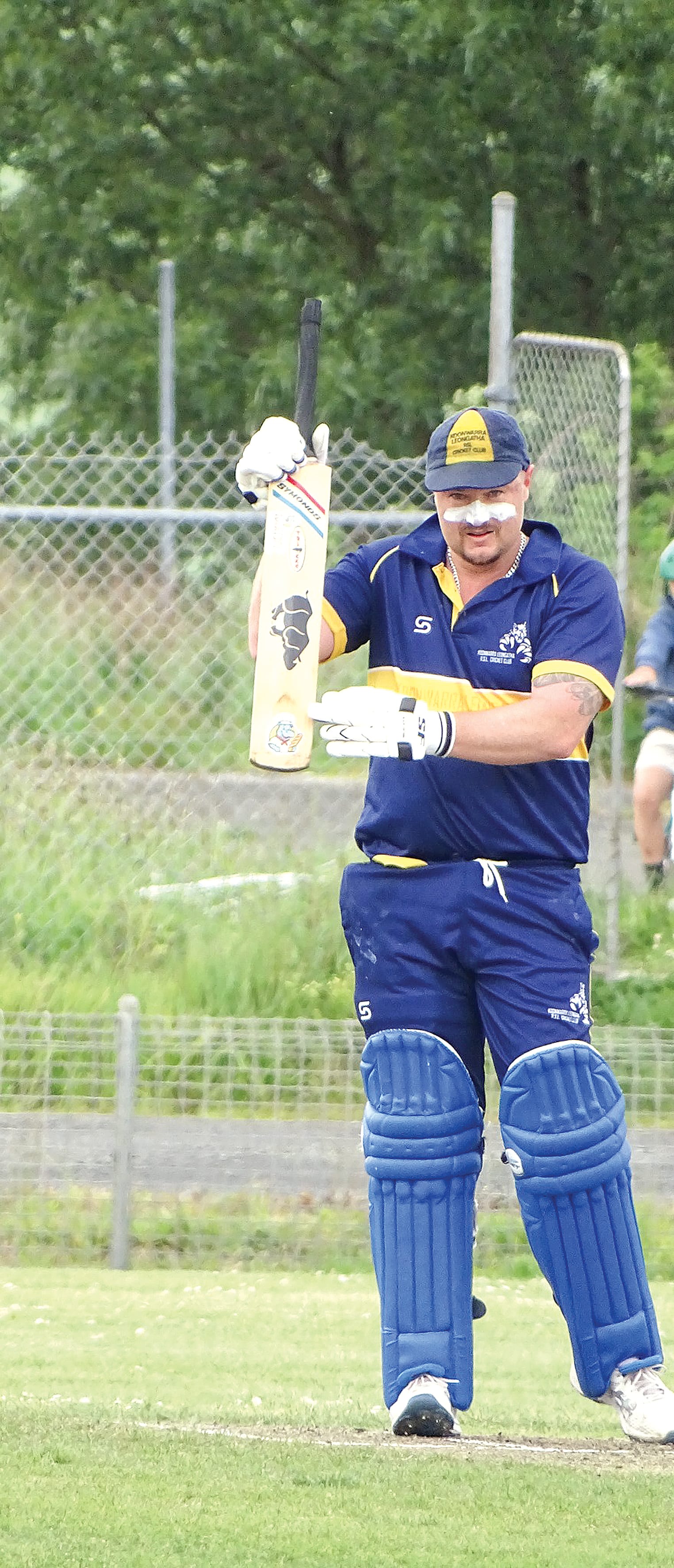 Jimmy Rushton celebrates 50, pointing to Thornton’s Bakery sticker on the bat. Photo: Jodie Arnup.