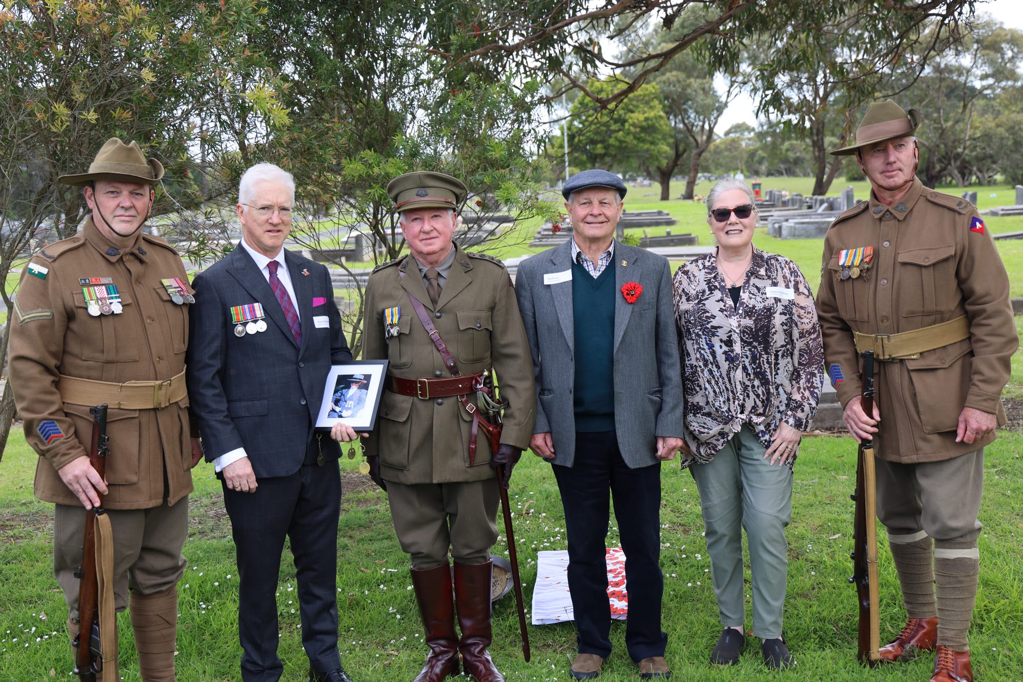 Lawrence Buck, Michael Reardon and Michael Crump from the Phillip Island sub-branch of the RSL with Tony Matthews, Geoff Lee and Angela Matthews at the grave of Private William (Bill) Abraham Matthews in the Wonthaggi Cemetery. B39_4625