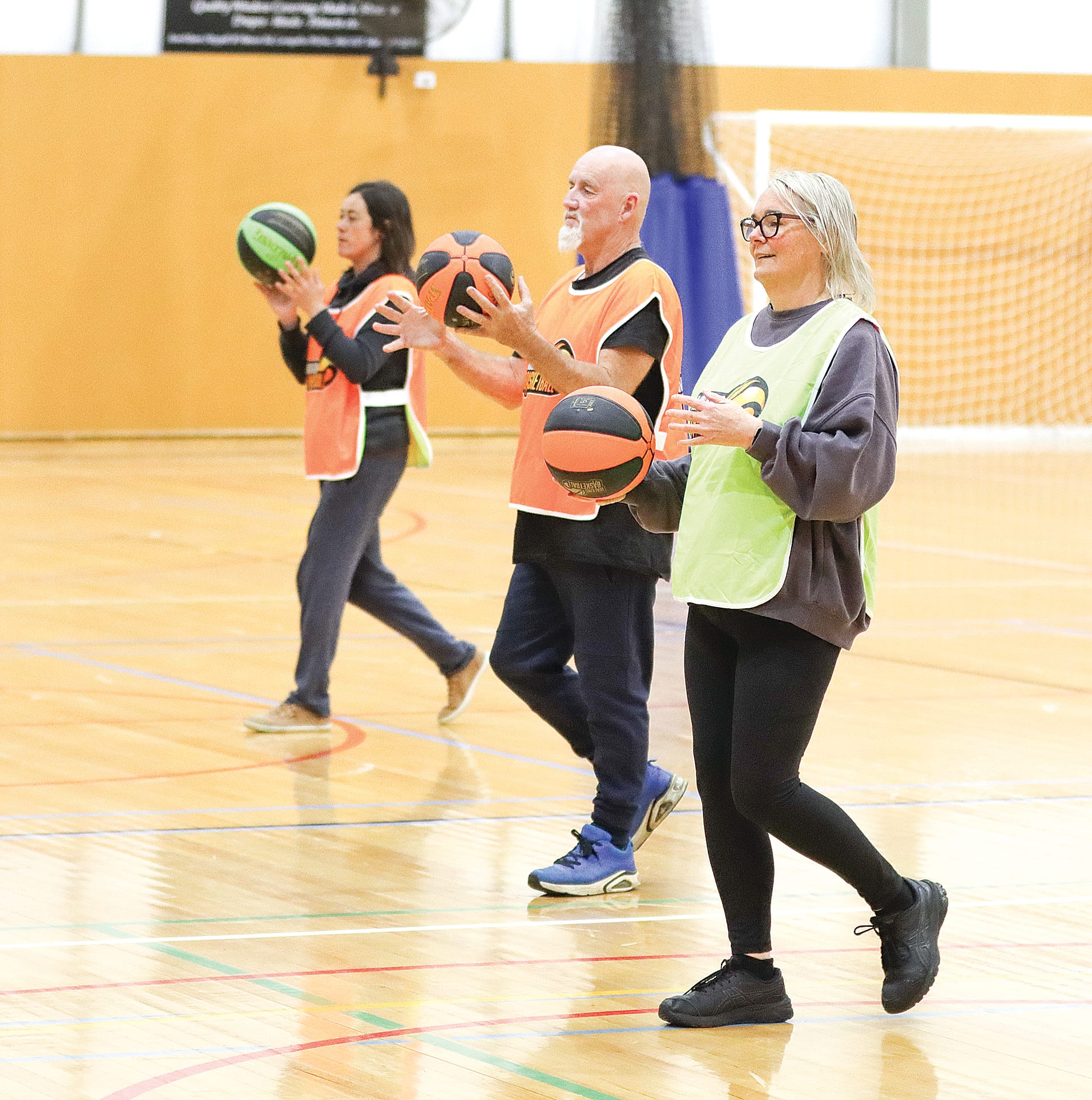 Emma Parkes, Paul Lewis and Karyn Calvert warm up for Walking Basketball. A05_4425