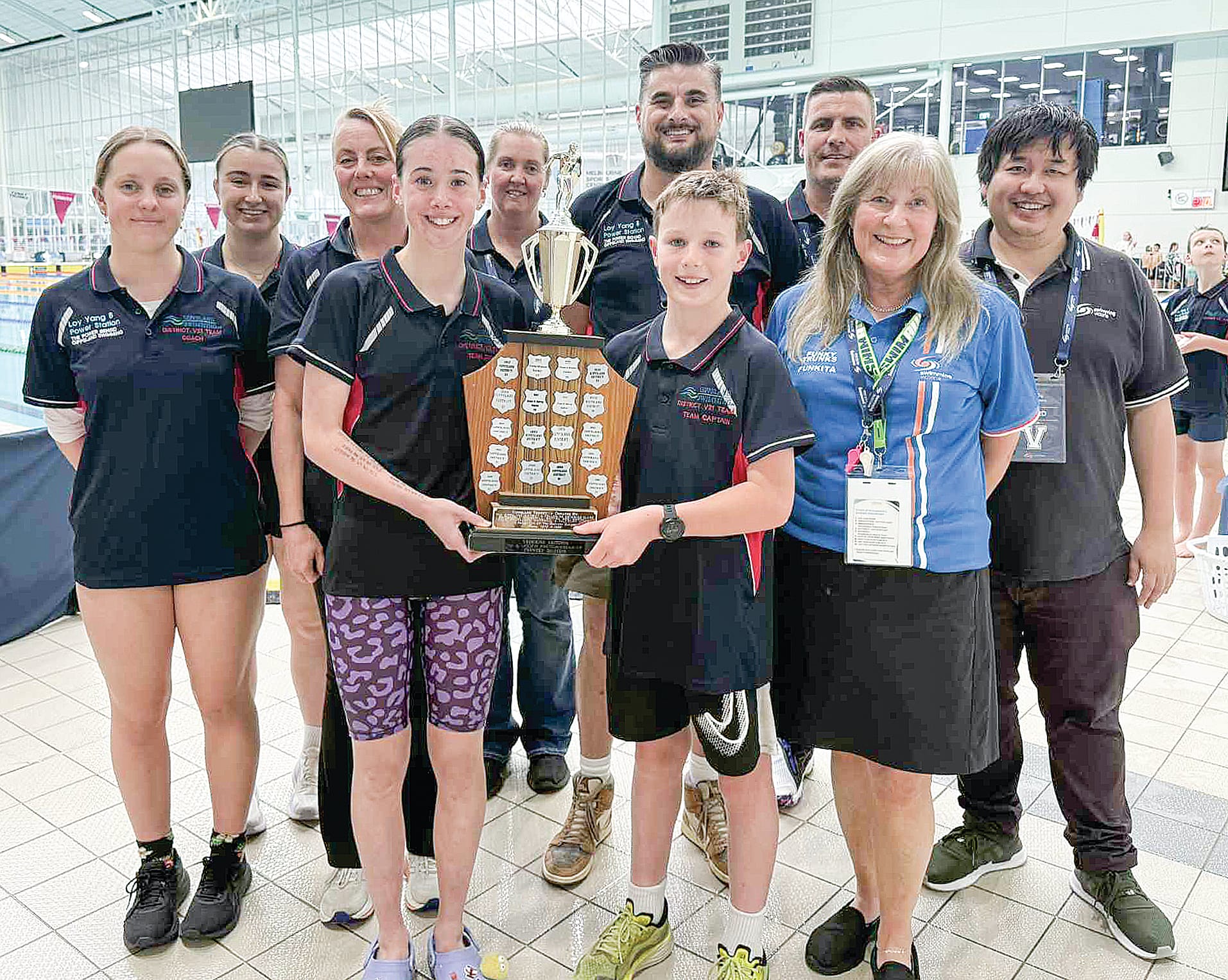 The captains, coaches, team managers and officials celebrate the Gippsland junior swimmer’s 42nd consecutive win.