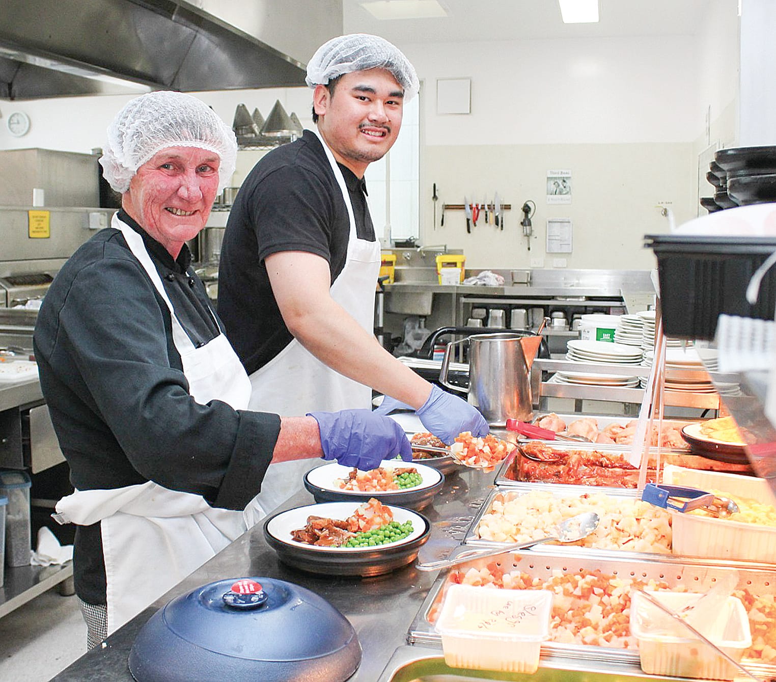 Chefs Glenda Churchill and Myint Soe prepare lunch for patients at the Wonthaggi Hospital and residents of Kirrak House residential aged care home.