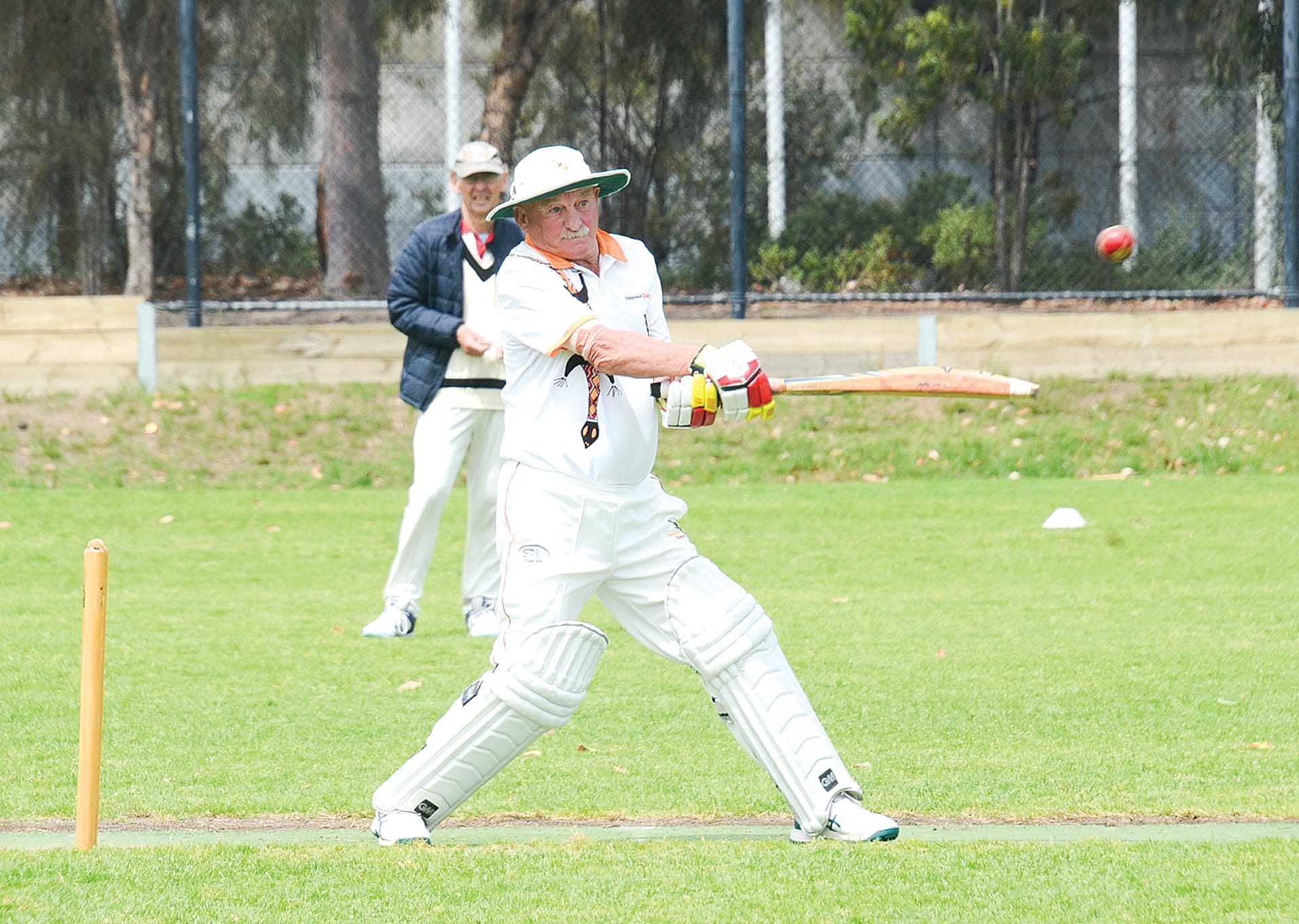 Gippsland Goannas president Neil Meredith cuts during his innings of 34 not out.  Ian Southall is the square leg umpire.
