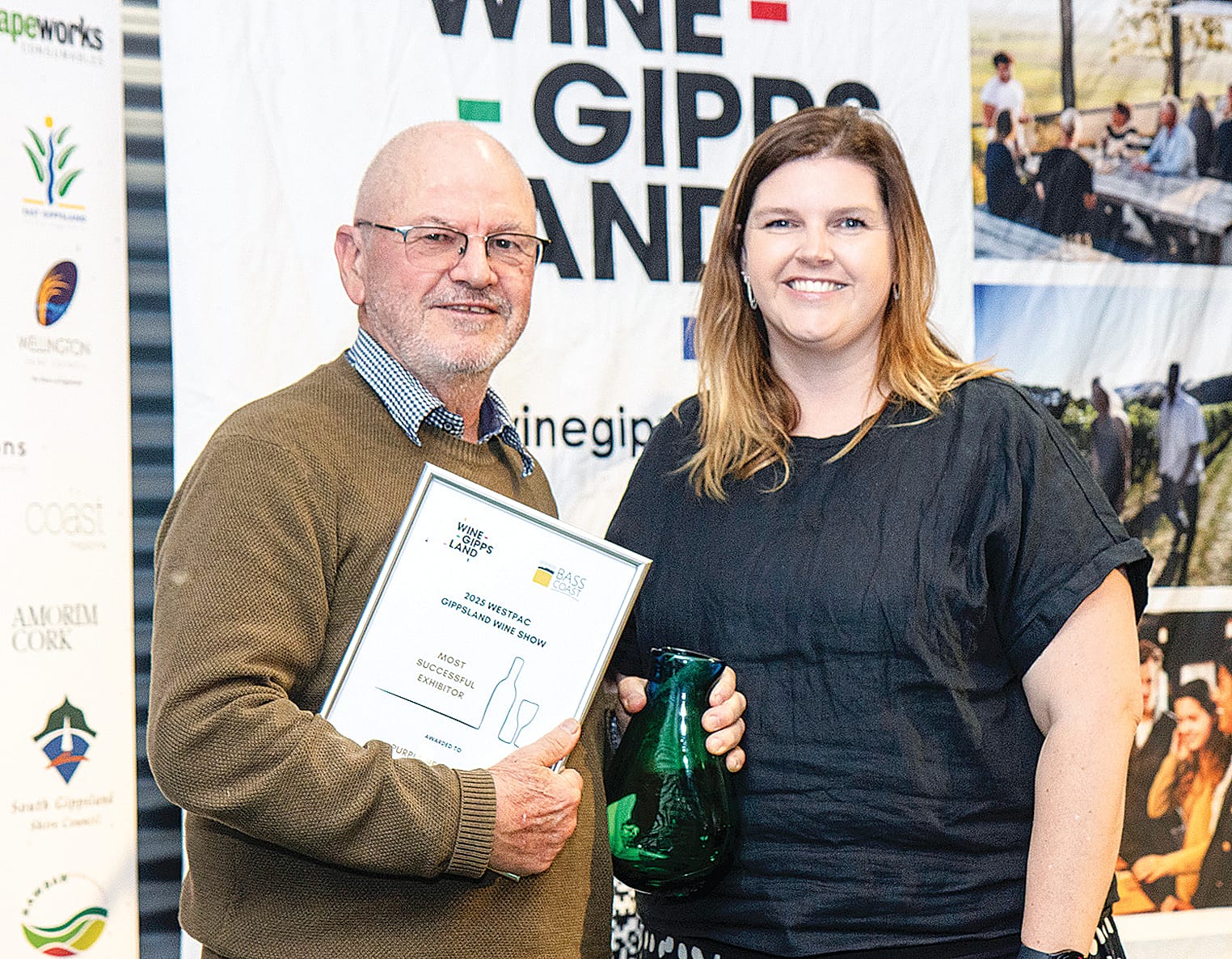 Rick Lacey of Purple Hen Winery, Phillip Island, accepts the trophy for Most Successful Exhibitor from Lauren Van Strijp of Bass Coast Shire Council.